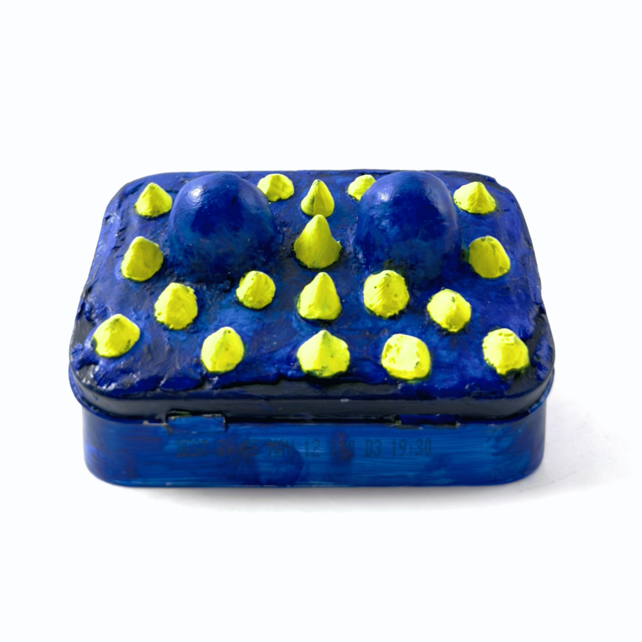 Back view of an original mixed media sculpture of a toothy monster inside a classic Altoid tin by Diantha Boardman.