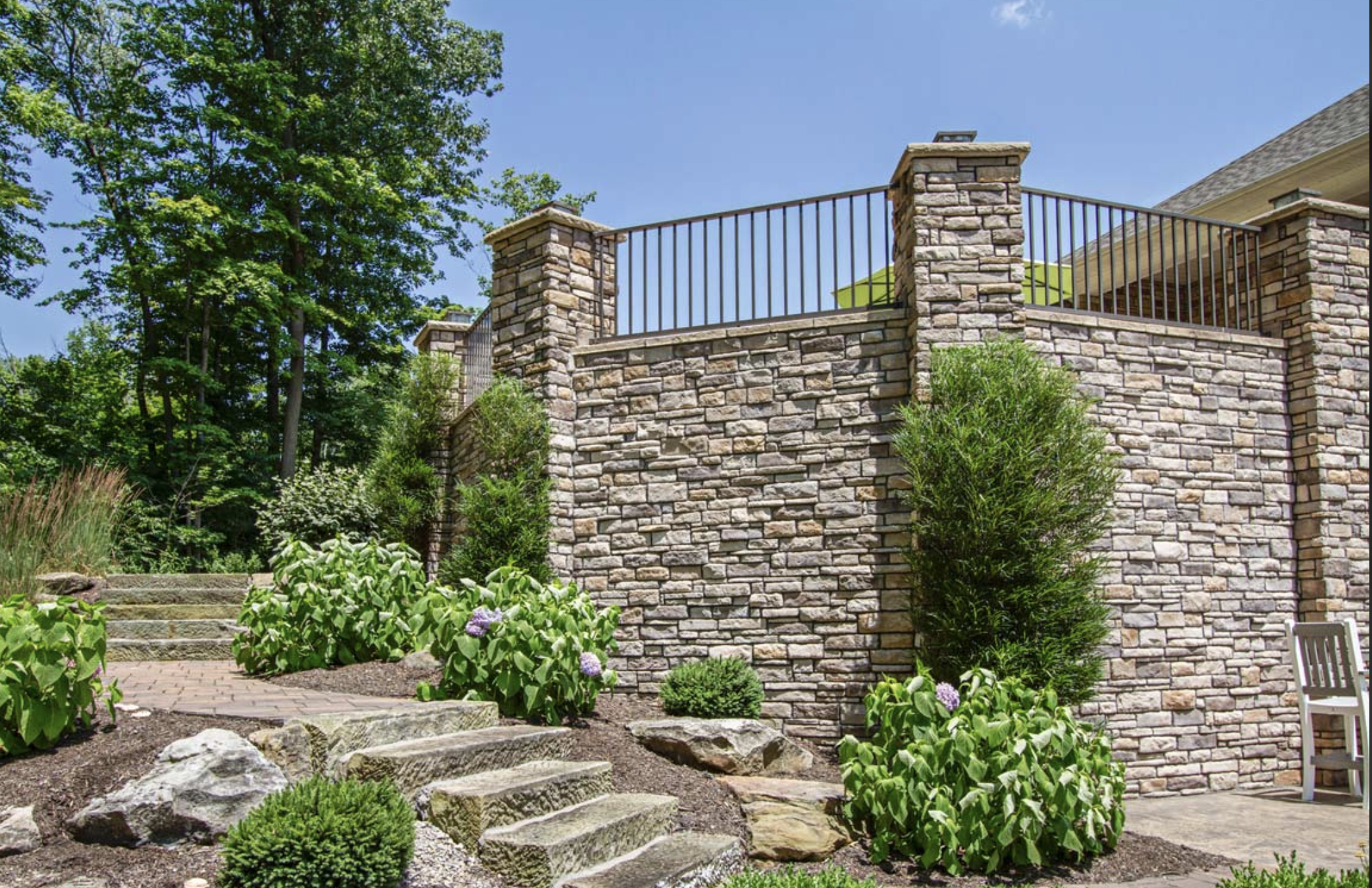 Natural stone retaining wall and patio steps built with materials from a landscape supply yard in the Lehigh Valley, PA.