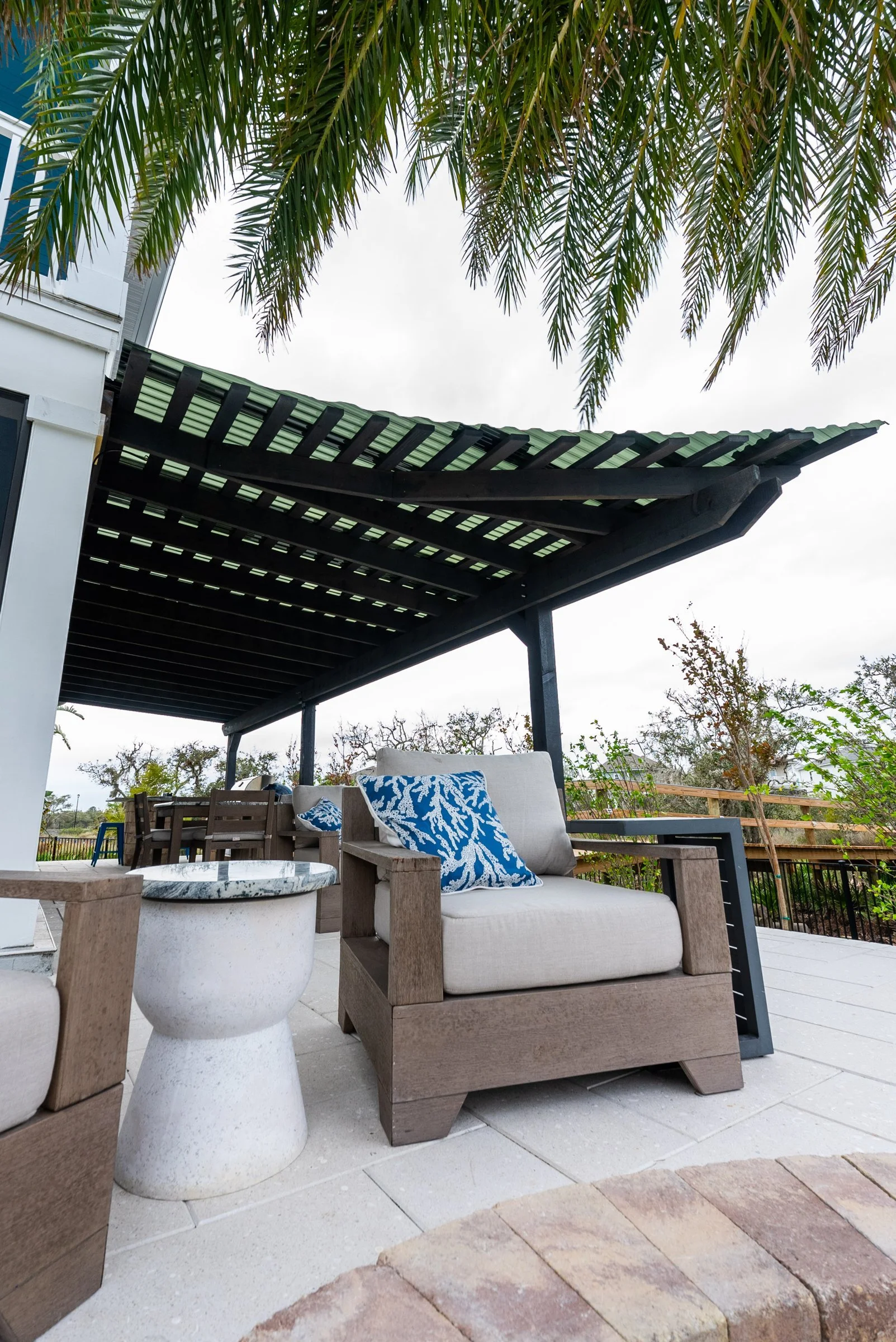 Lounge seating under a custom cedar pergola, St. Augustine