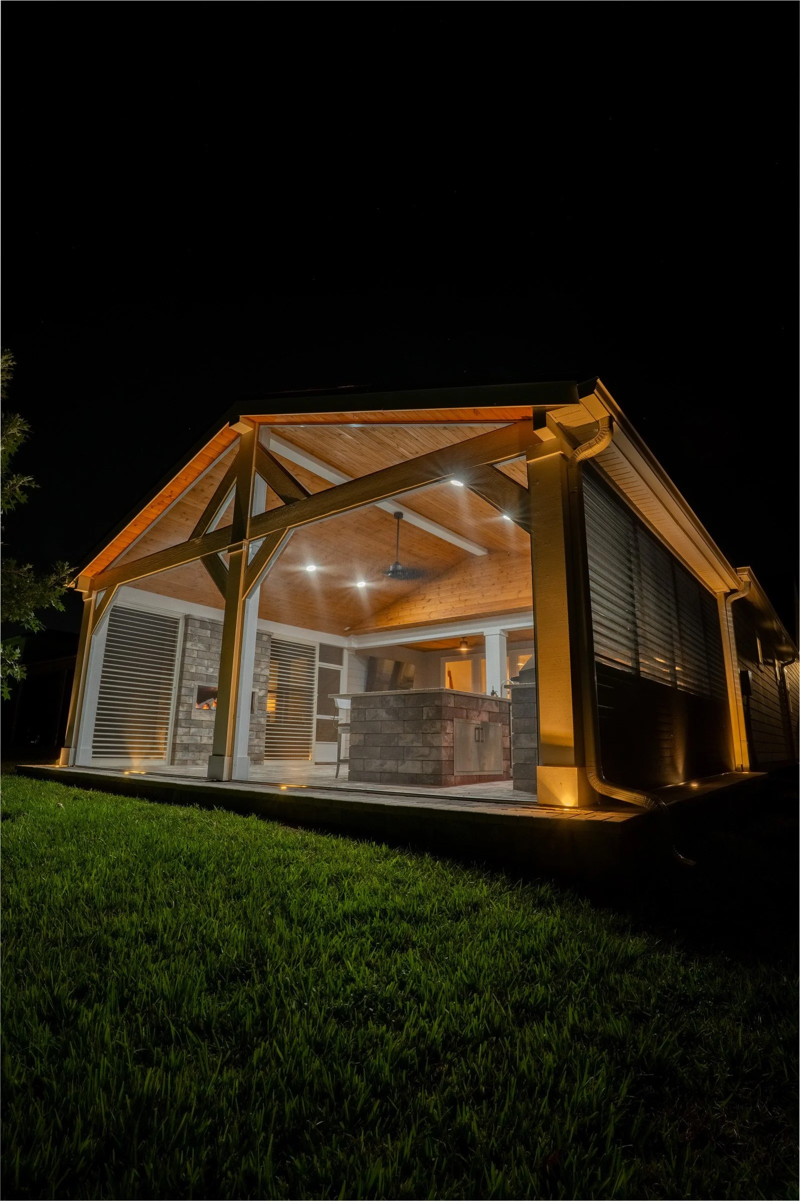 Tied-in cedar gazebo inside a screen enclosure at night, Del Webb Nocatee