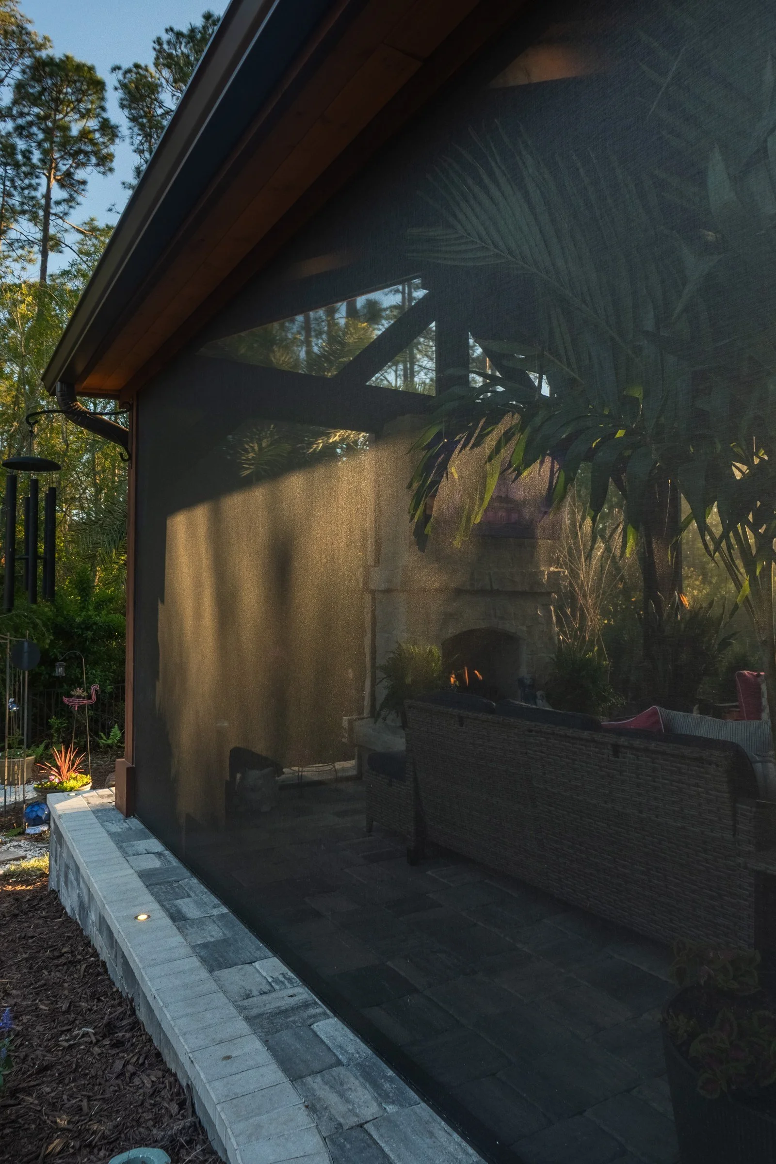 Screened cedar gazebo with paver border at dusk, Cypress Trails, Nocatee
