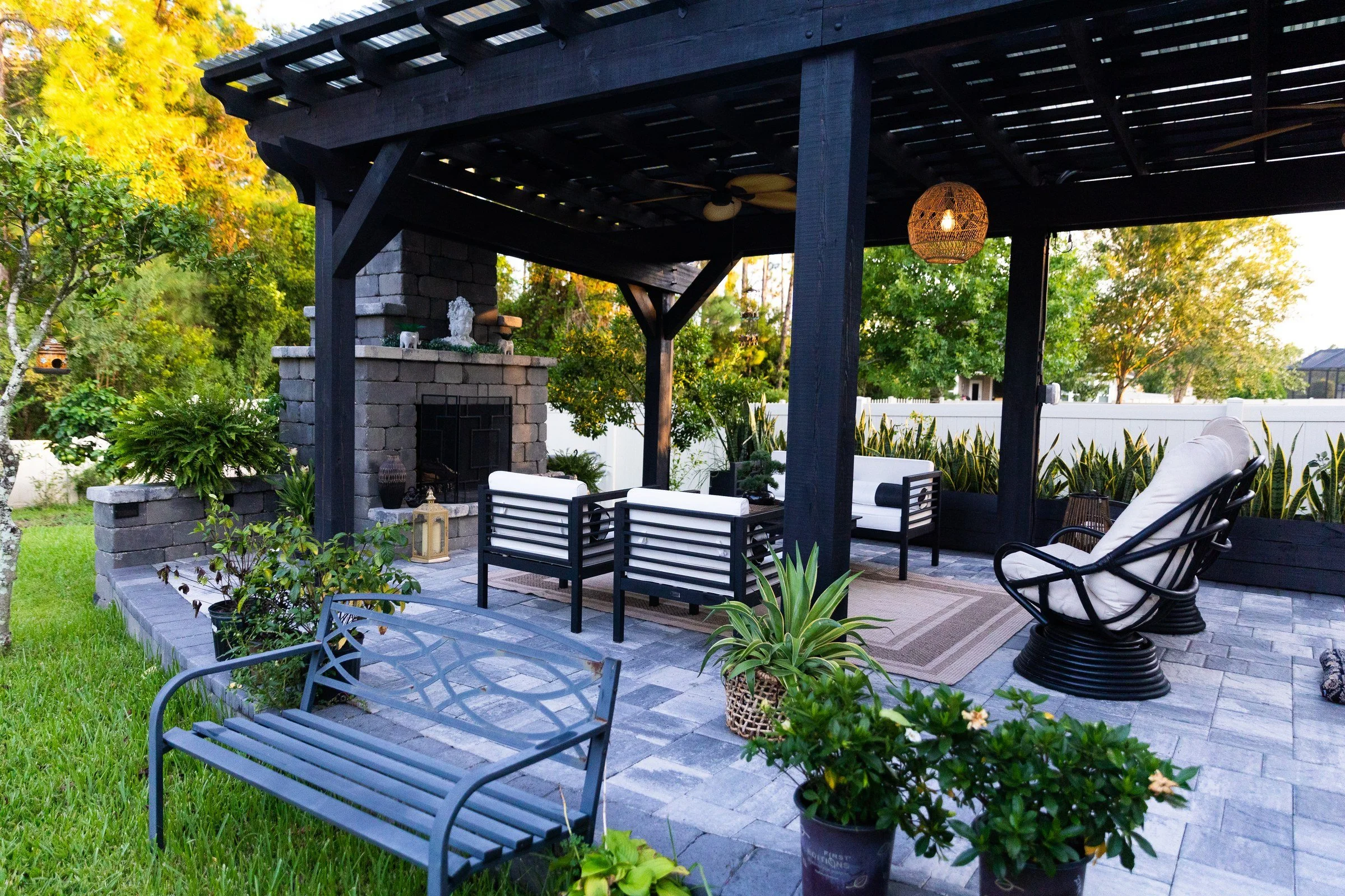 Black cypress pergola over a paver patio in Orange Park, FL by AY Luxury Designs