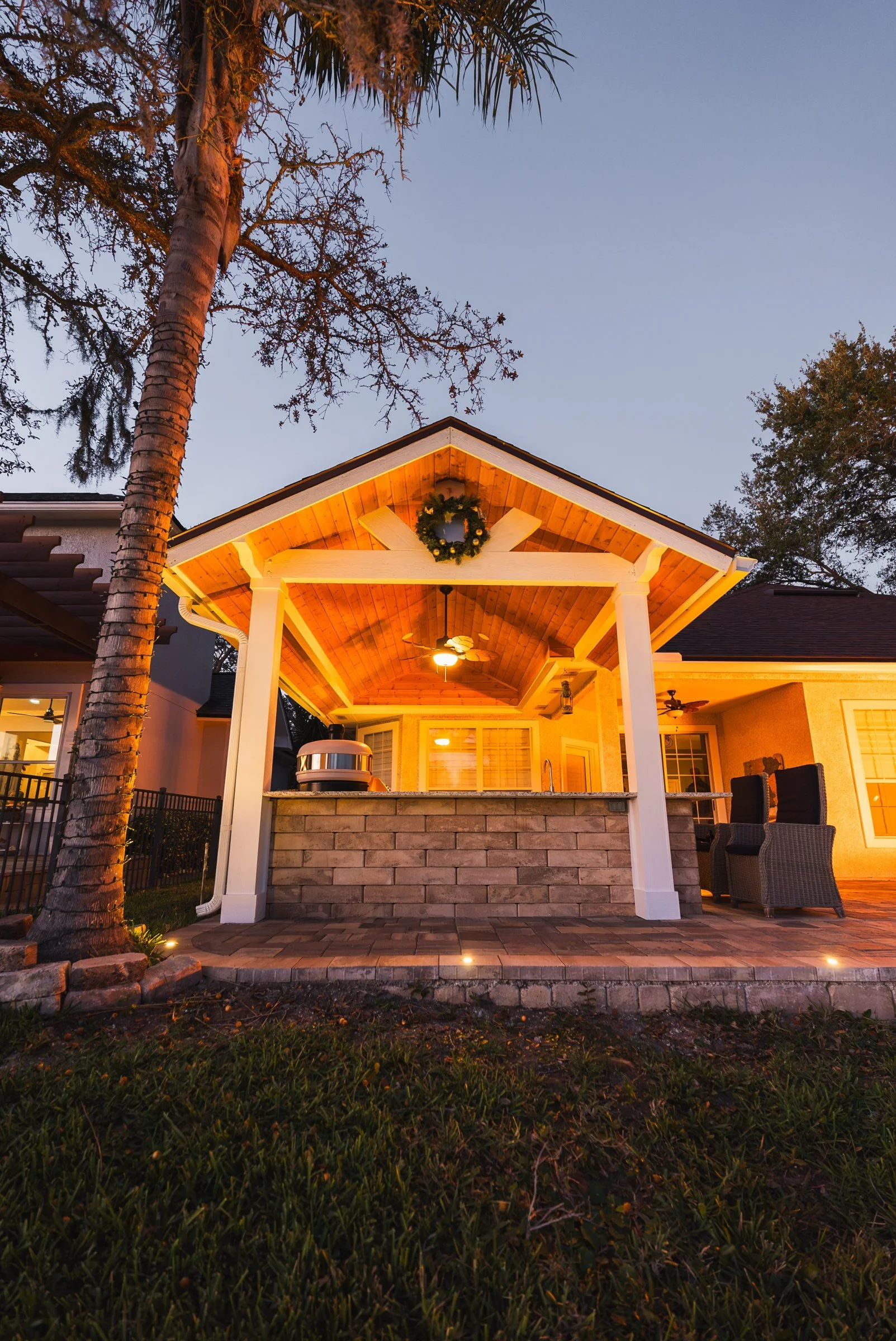 A-frame cedar gazebo at twilight in Ponte Vedra Beach, FL by AY Luxury Designs