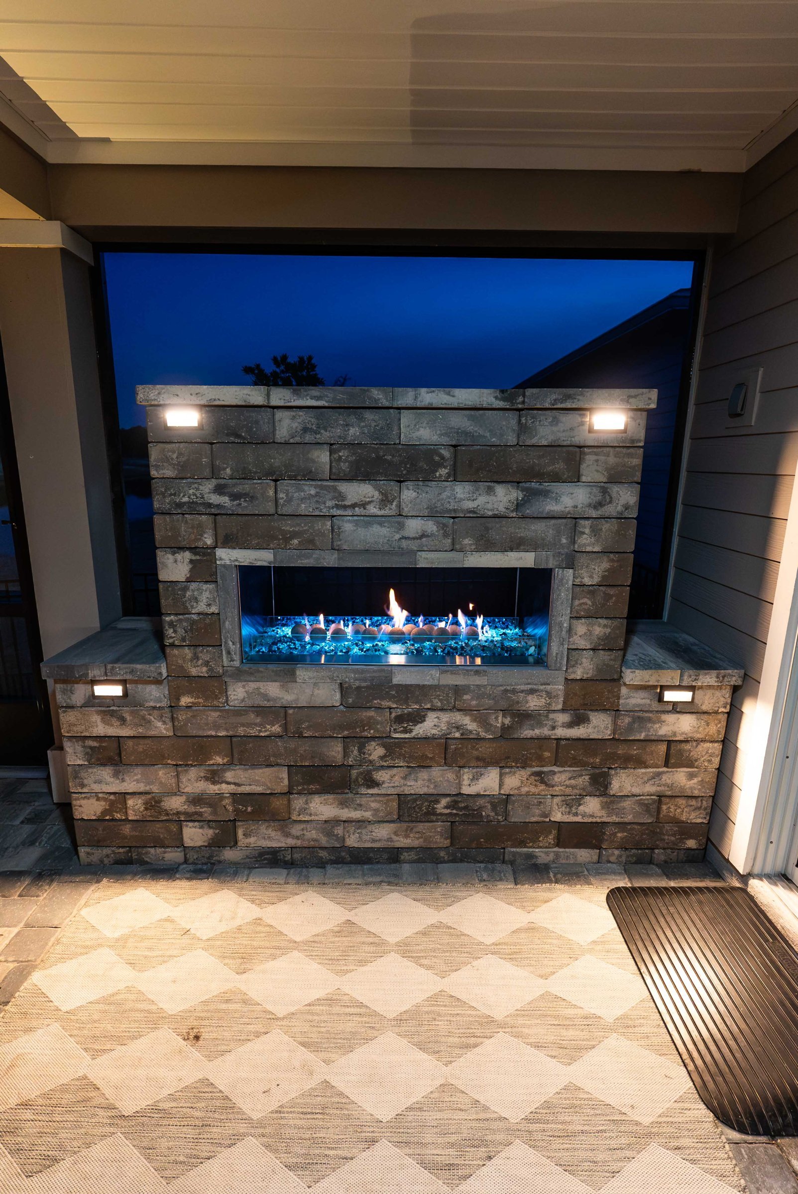 Linear fireplace with lighted walls in a screen enclosure, Stillwater, St. Johns FL