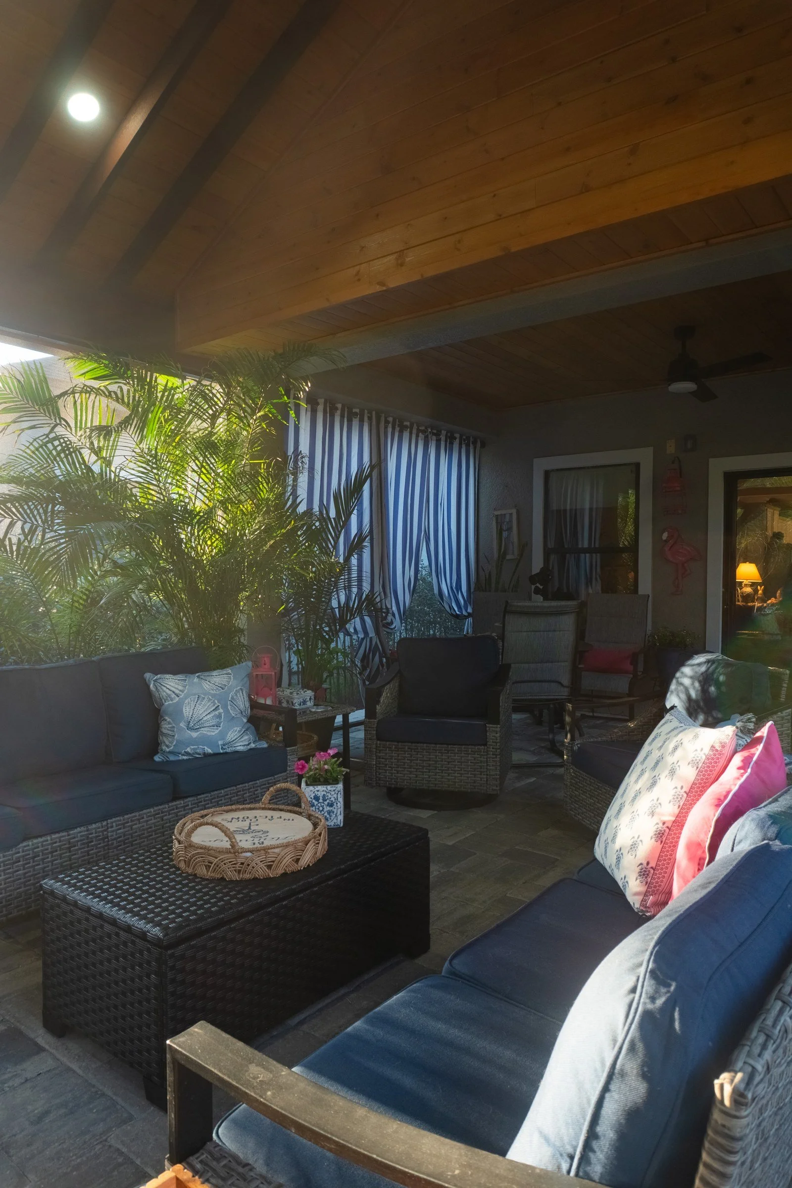 Screened outdoor lounge under a cedar tongue-and-groove ceiling, Nocatee