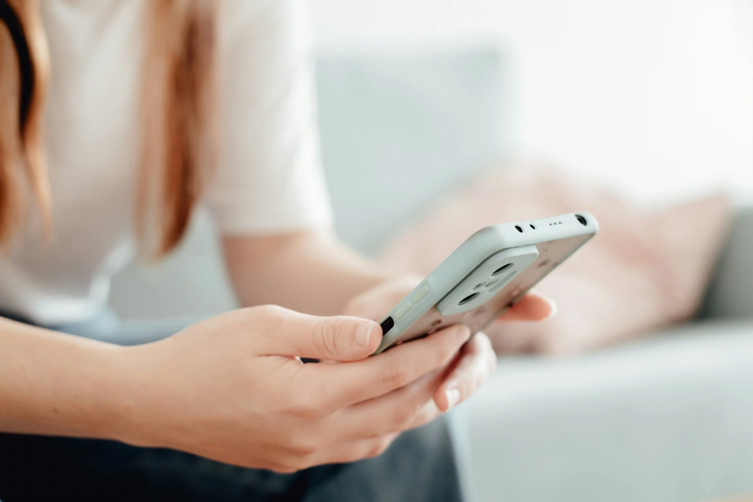 womans hands holding phone