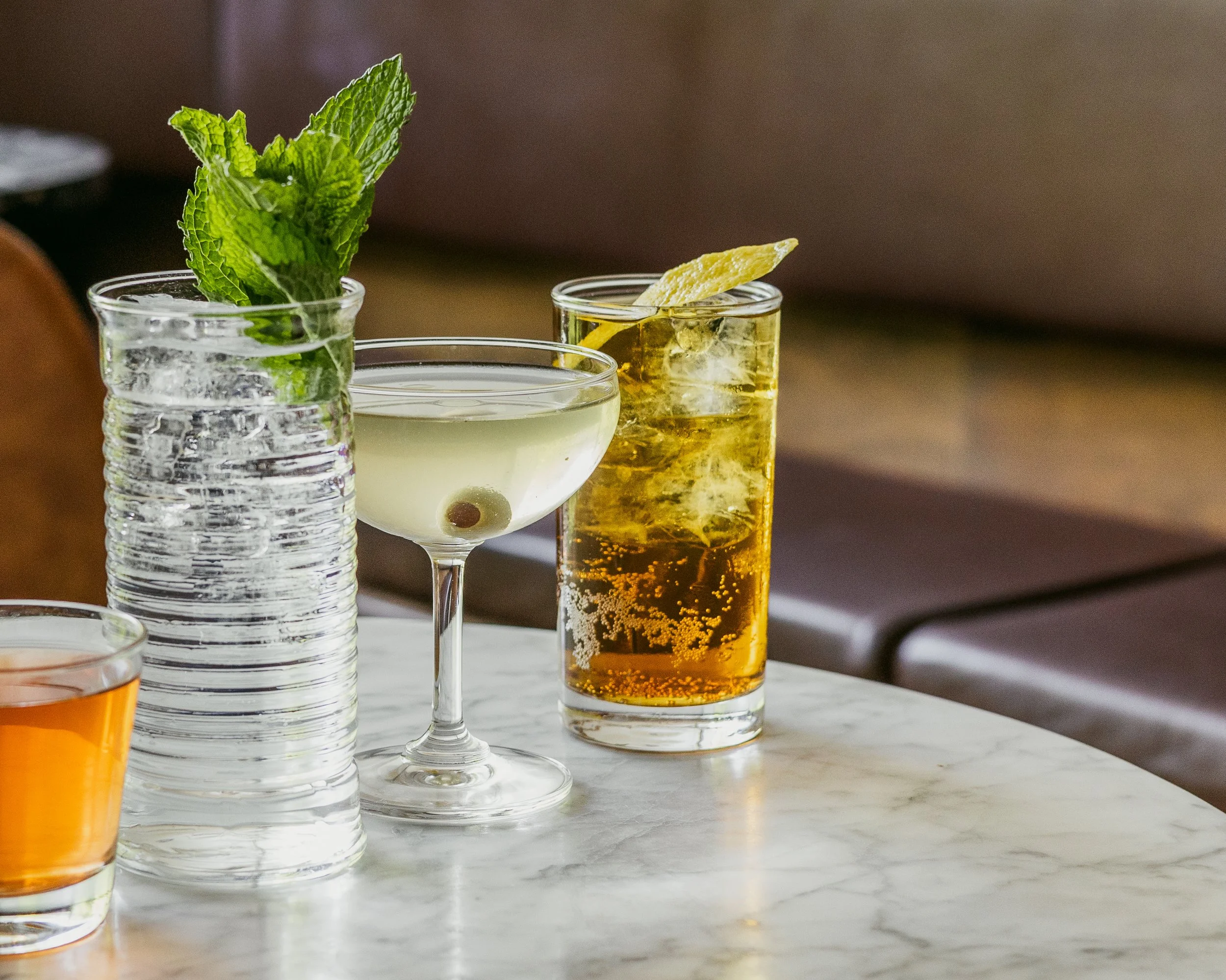 Multiple different cocktails on a marble table at Plain Spoke Cocktails, Madison, WI