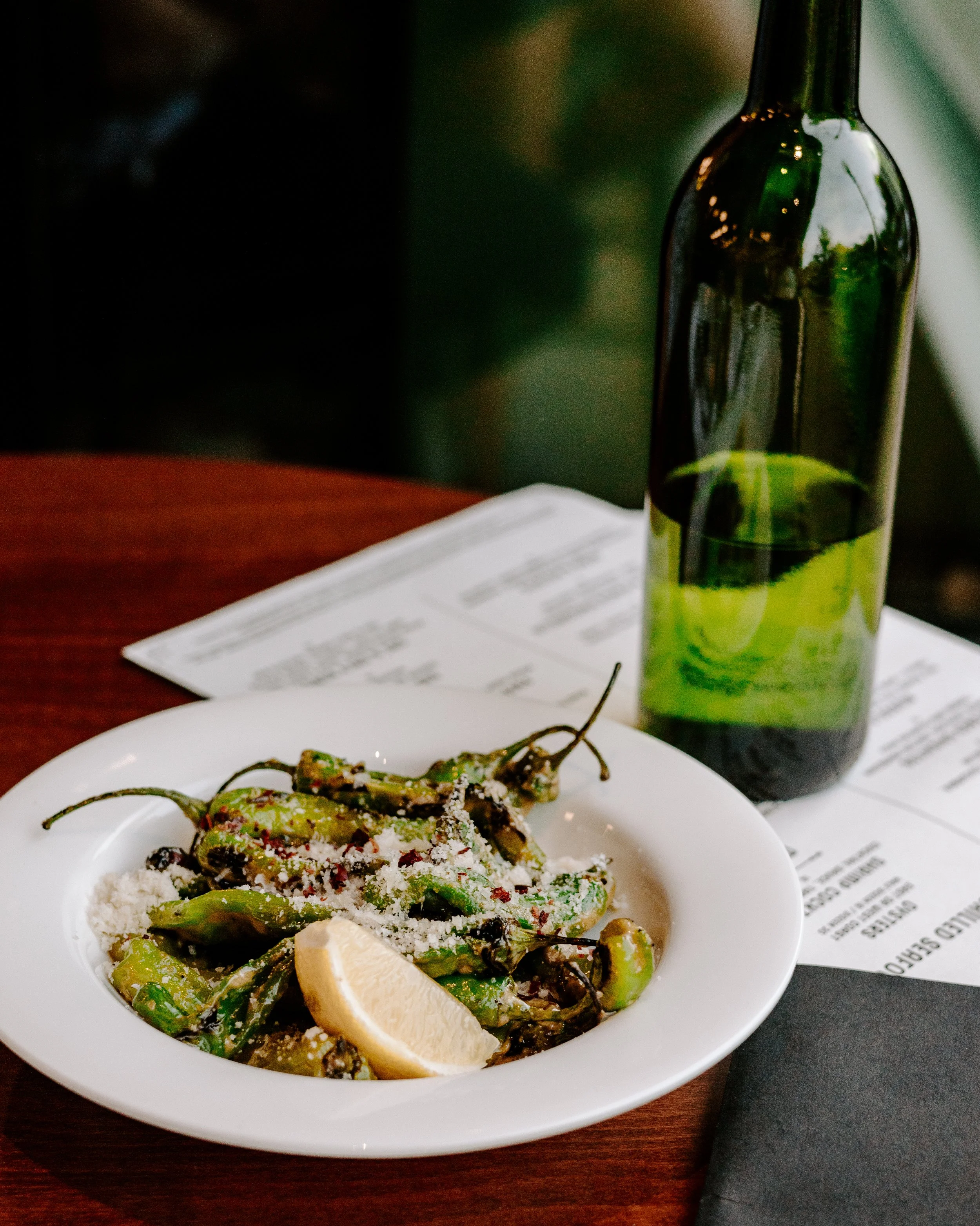 A plate of shishito peppers and lemon at One and Only, Madison, WI