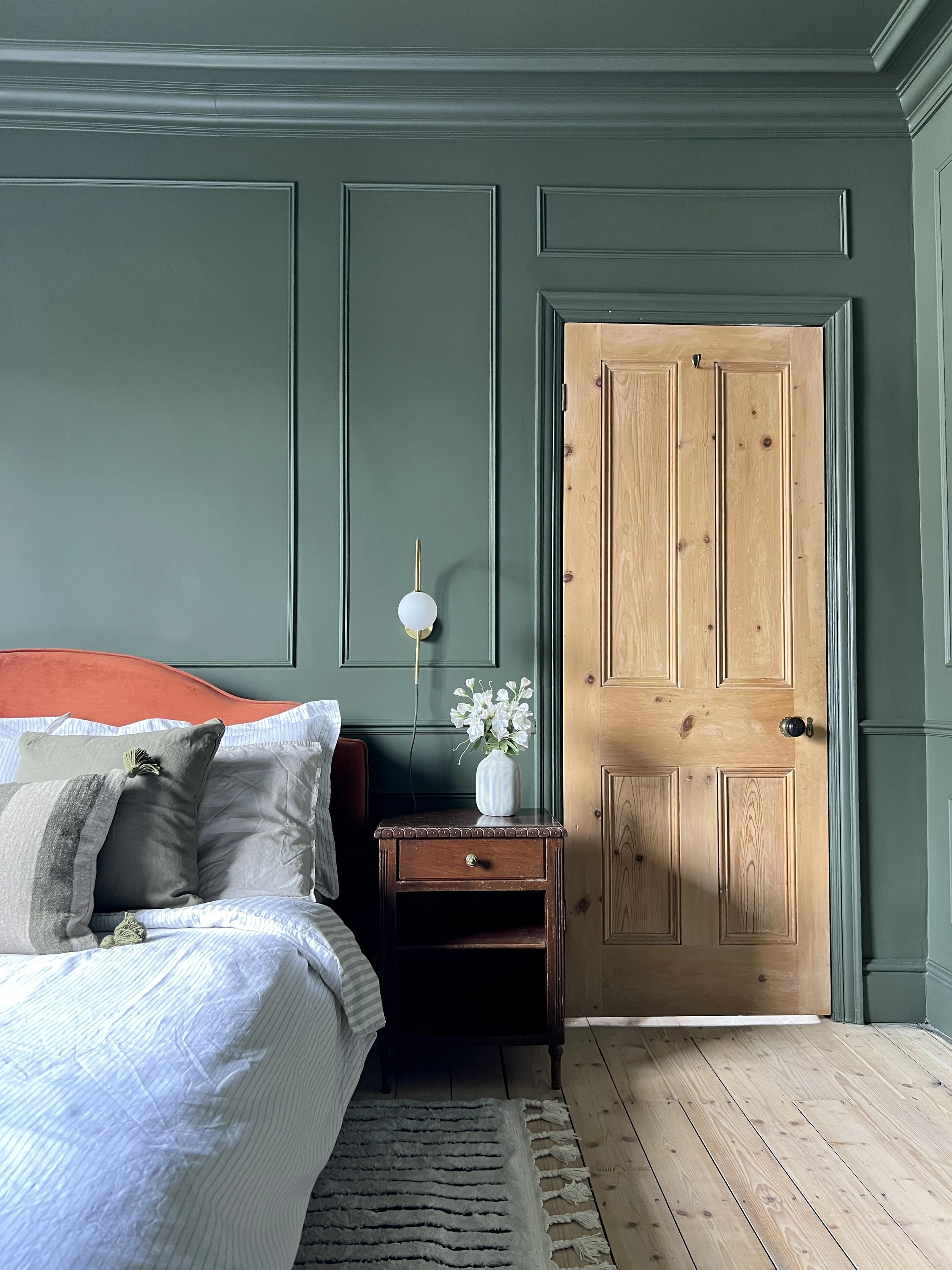 Green bedroom with panelling