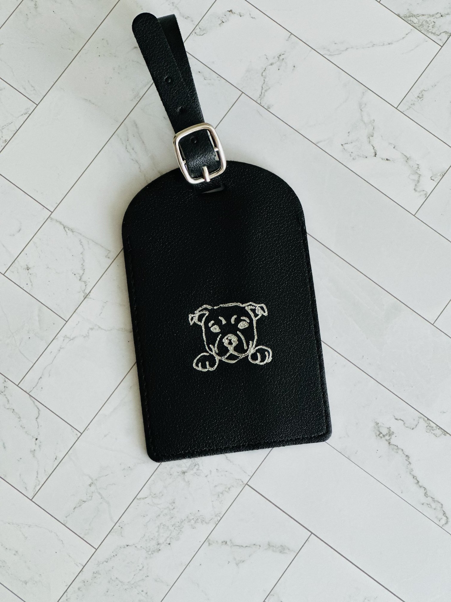 Leather luggage tag personalized with a hot-foiled dog design, live hot foiling in Los Angeles