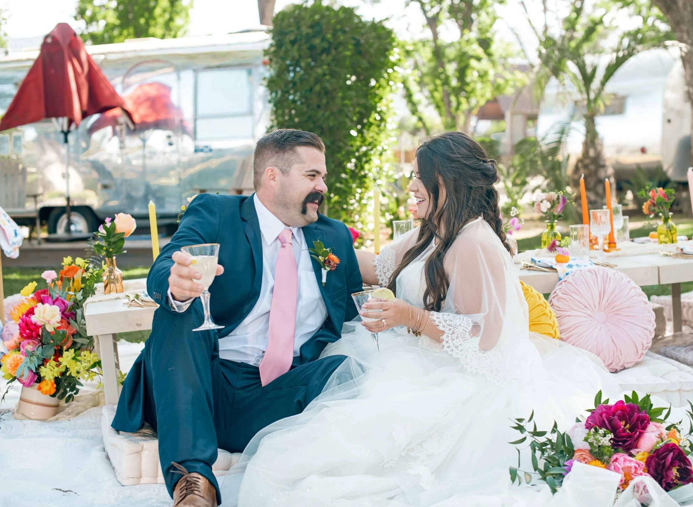 A couple celebrating their wedding day on the lawn at Launch Pointe wedding and events venue in Lake Elsinore, California.
