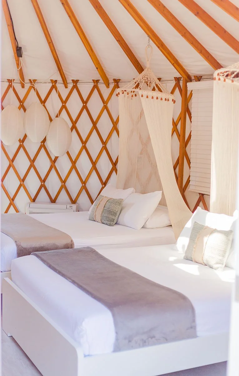 Two beds inside of a gorgeous yurt at Launch Pointe in Lake Elsinore, California.