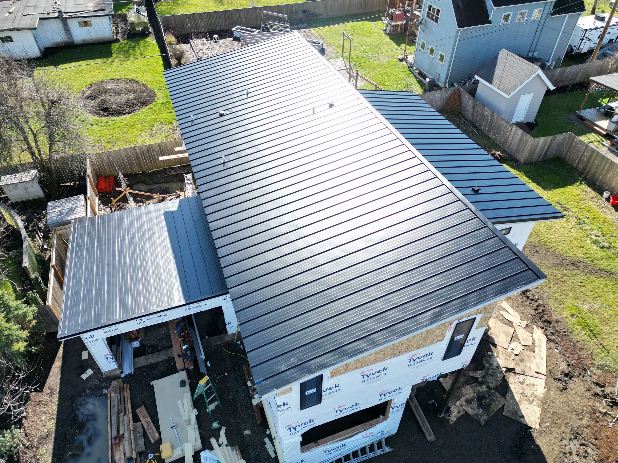 An aerial shot of a brand new roof installed by Helikson Homes.