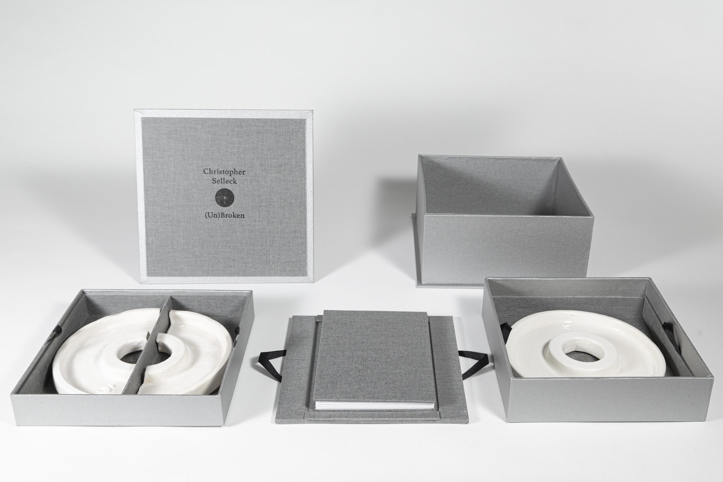 (Un)Broken, 2023-2024. 3 tiered box with ceramic weight plates and star accordion book.

A few years back on a return flight I sketched out a design for an ambitious artist book construction beyond my own level of skill. This project had been one of 