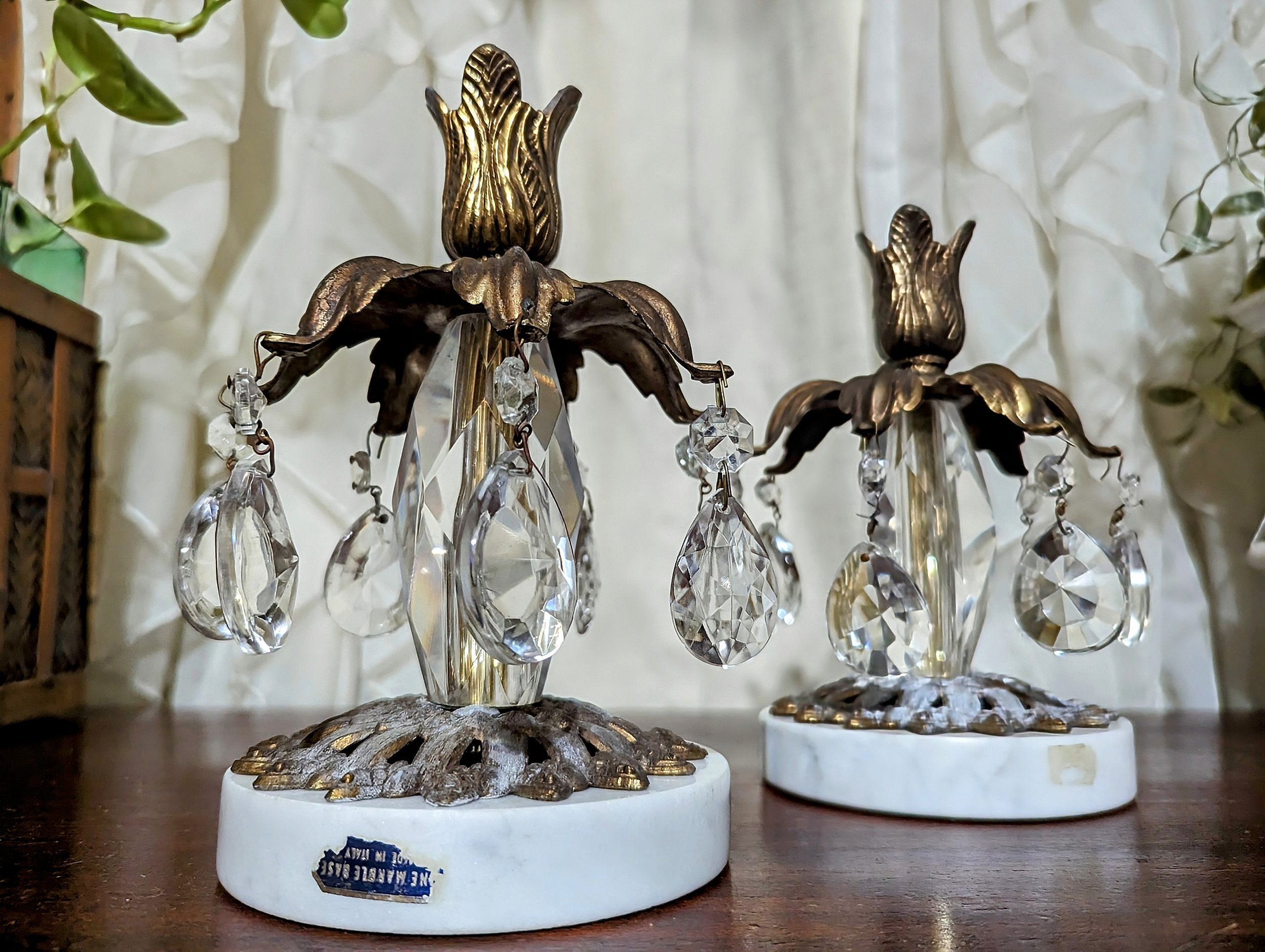 Hollywood regency style tapered candle holders. Regency flare, Floral shaped top with 7 functional extended leaves were all original crystals prisms are draped, Sturdy marble base made in Italy.