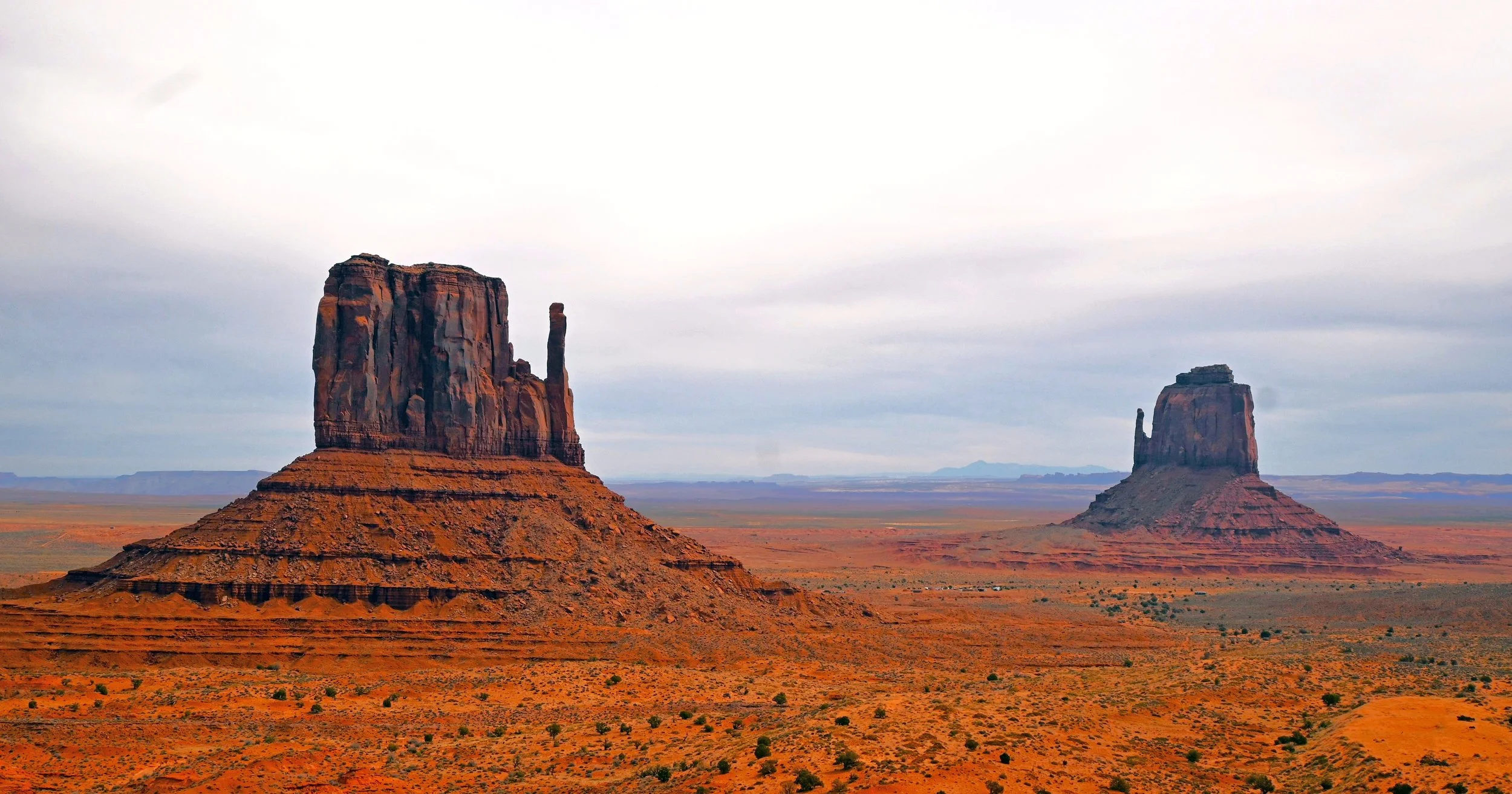 “Monument Valley” by Marilyn McCutcheon, featuring iconic sandstone buttes rising above the red desert landscape