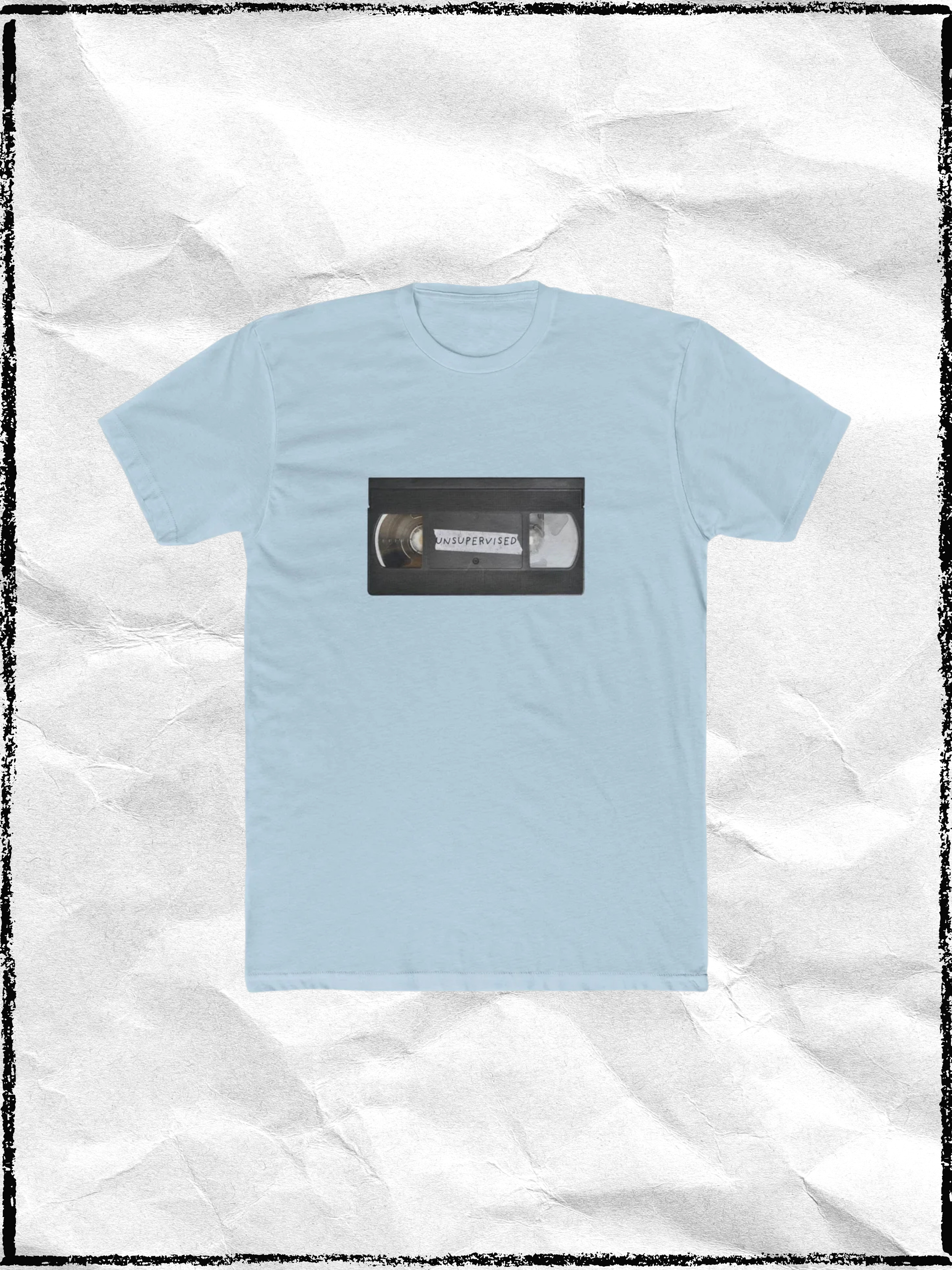 Light blue T-shirt with a printed image of a VHS tape labeled 'UNSUPERVISED' on the front.