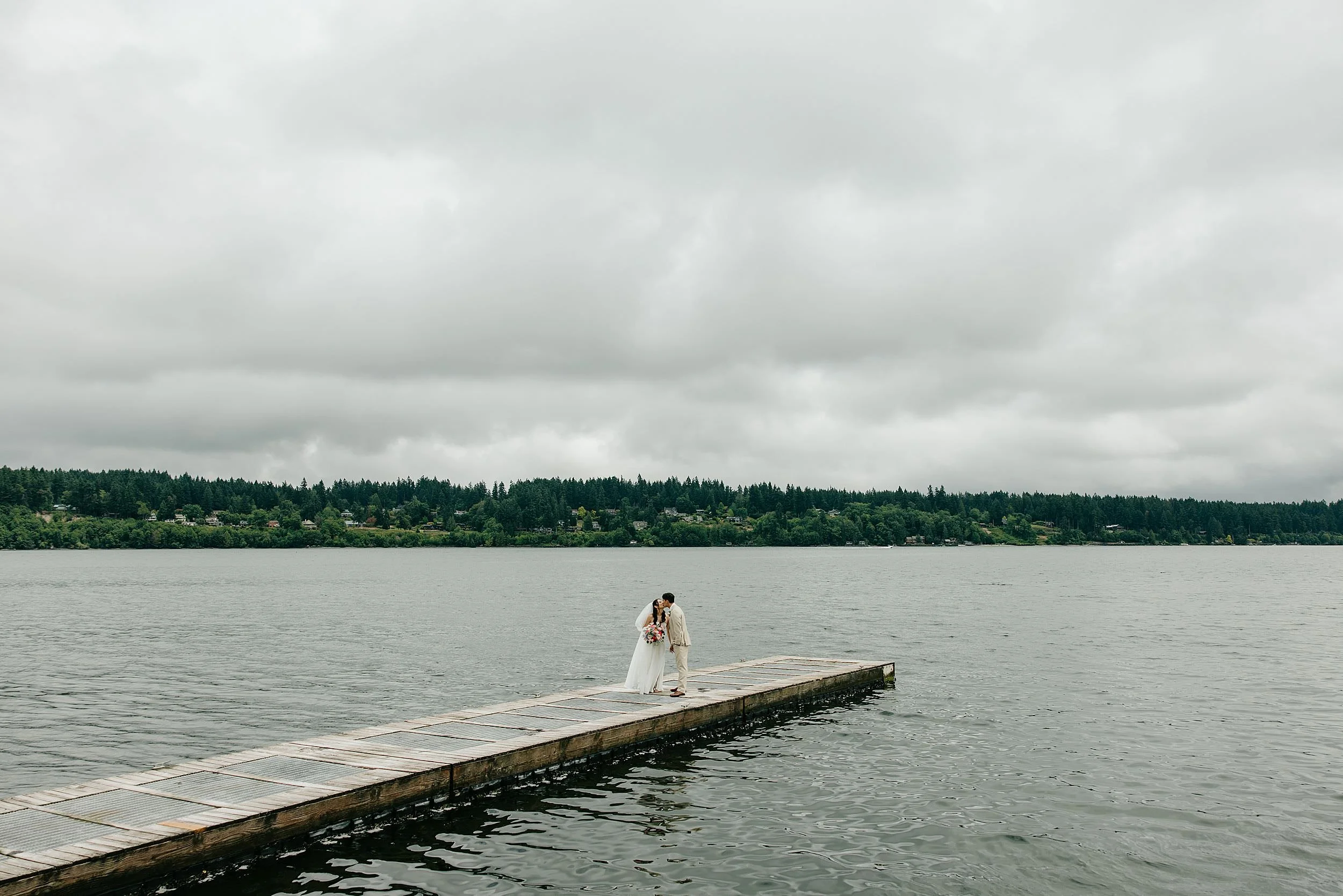 Couple on the dock at Kiana Lodge wedding in Poulsbo, WA.