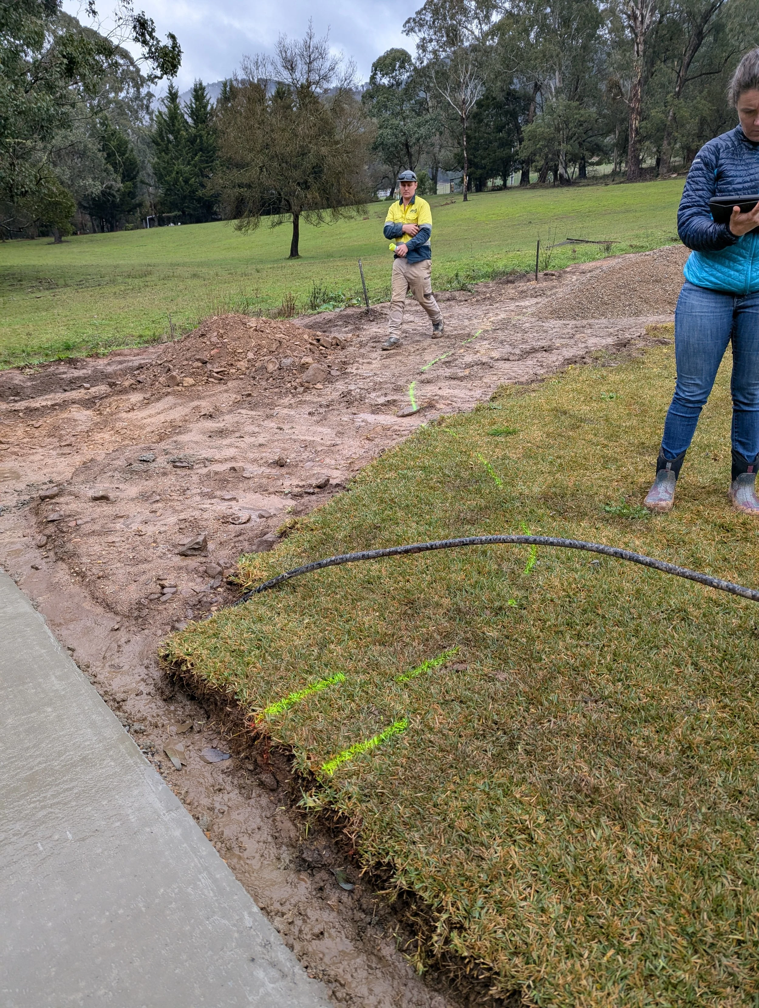 Emily on a site visit in the mud.jpg