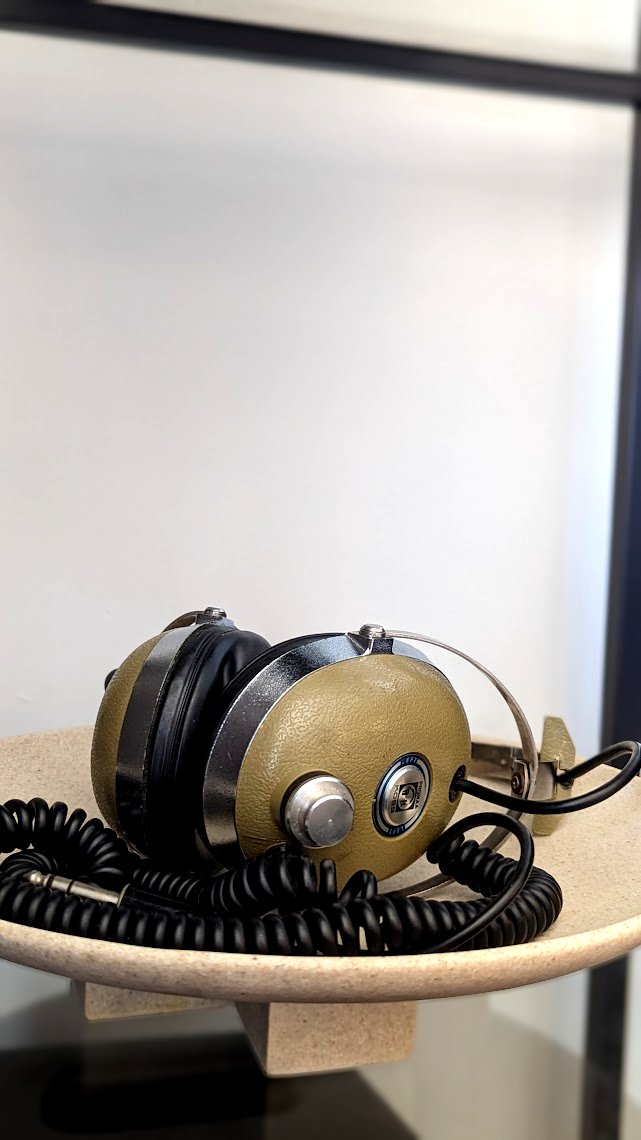 Close up Vintage Headphones in Dish Bookshelf Styling