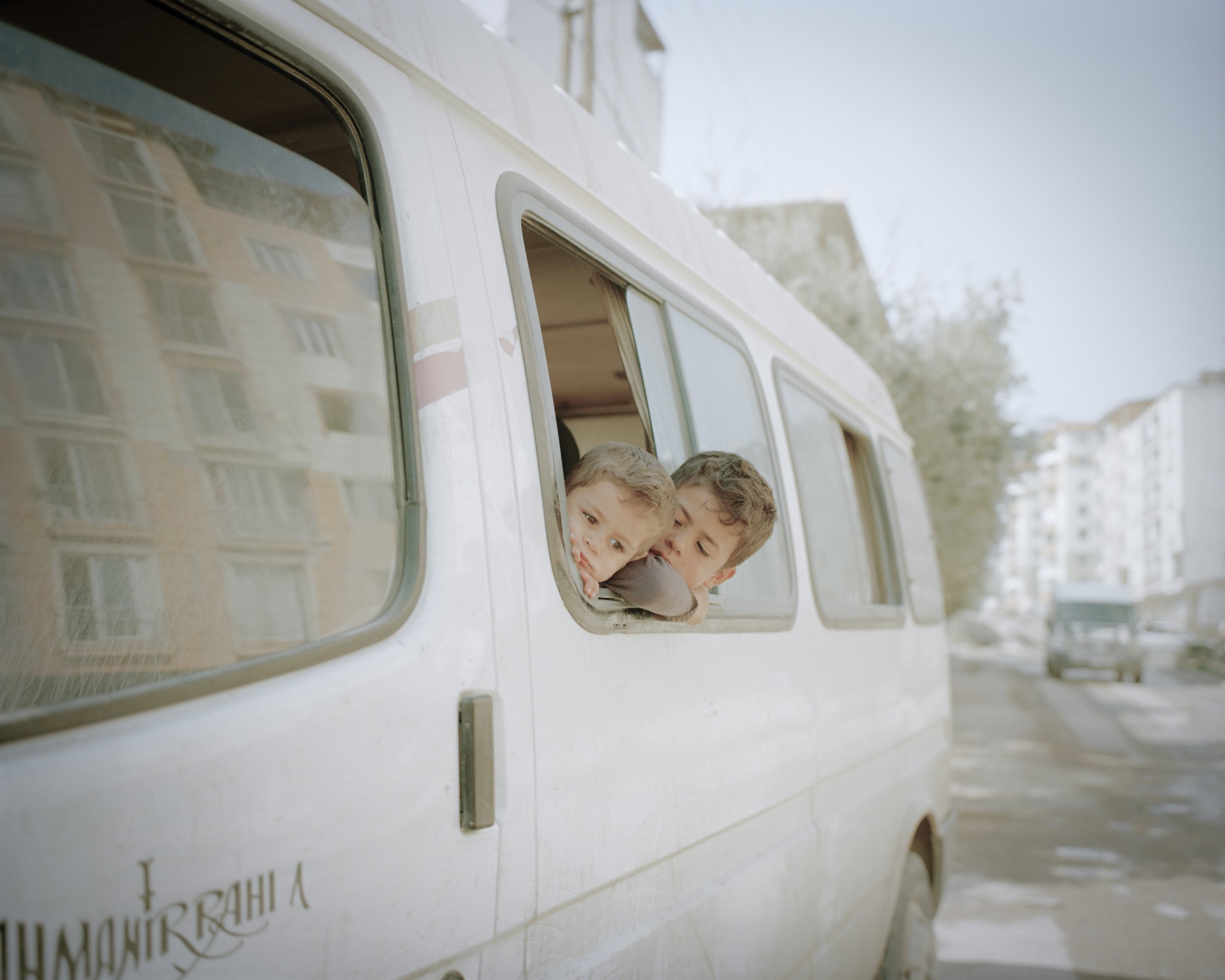 Children who play in the car that was abandoned in Kirikhan.
