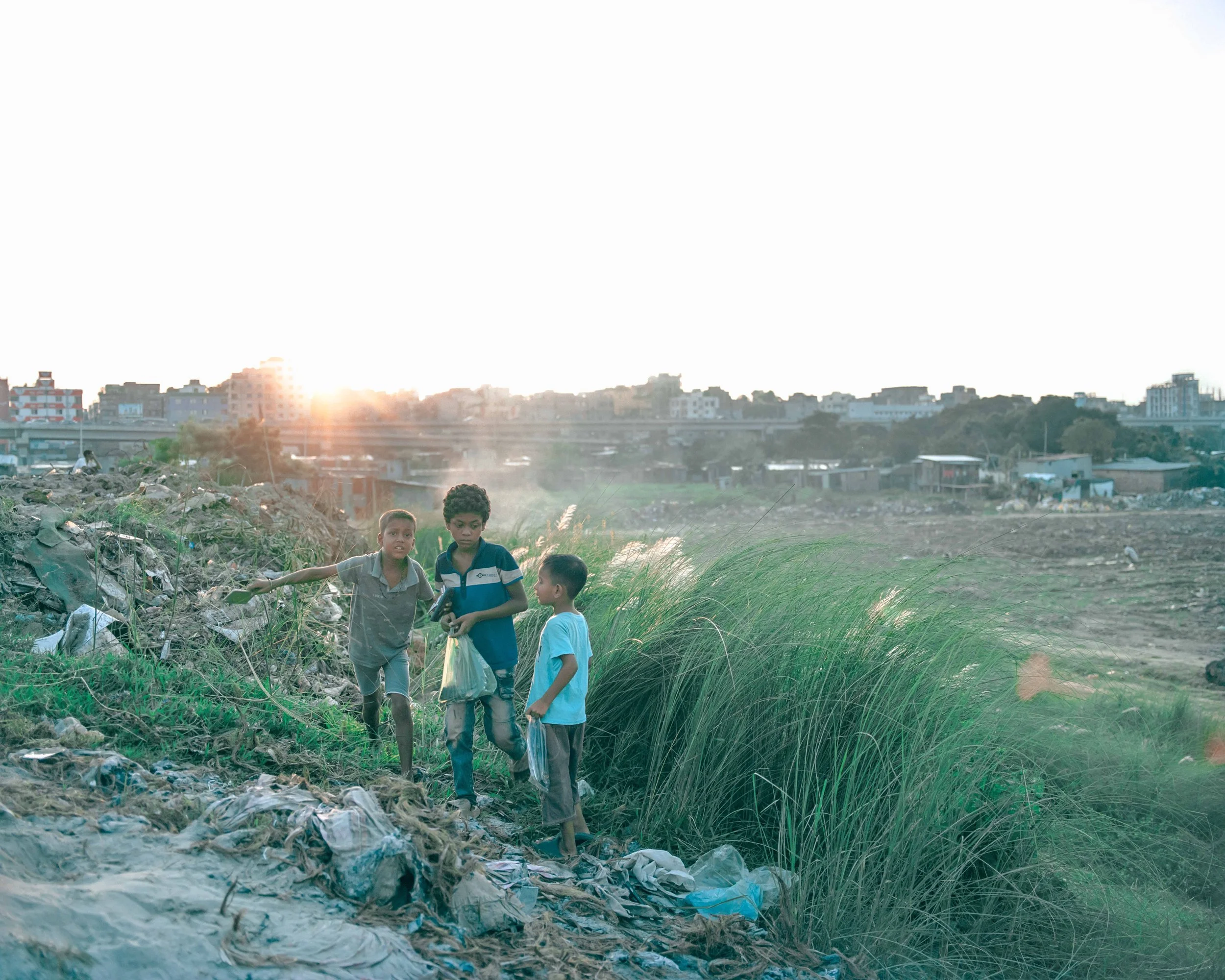 Young climate migrant boys collect smartphone cases near the Kalshi slum in Dhaka to sell as an additional source of household income. 
These cases are marketed at prices ranging from  approximately 20 to 70 taka, depending on their condition. 
Smart