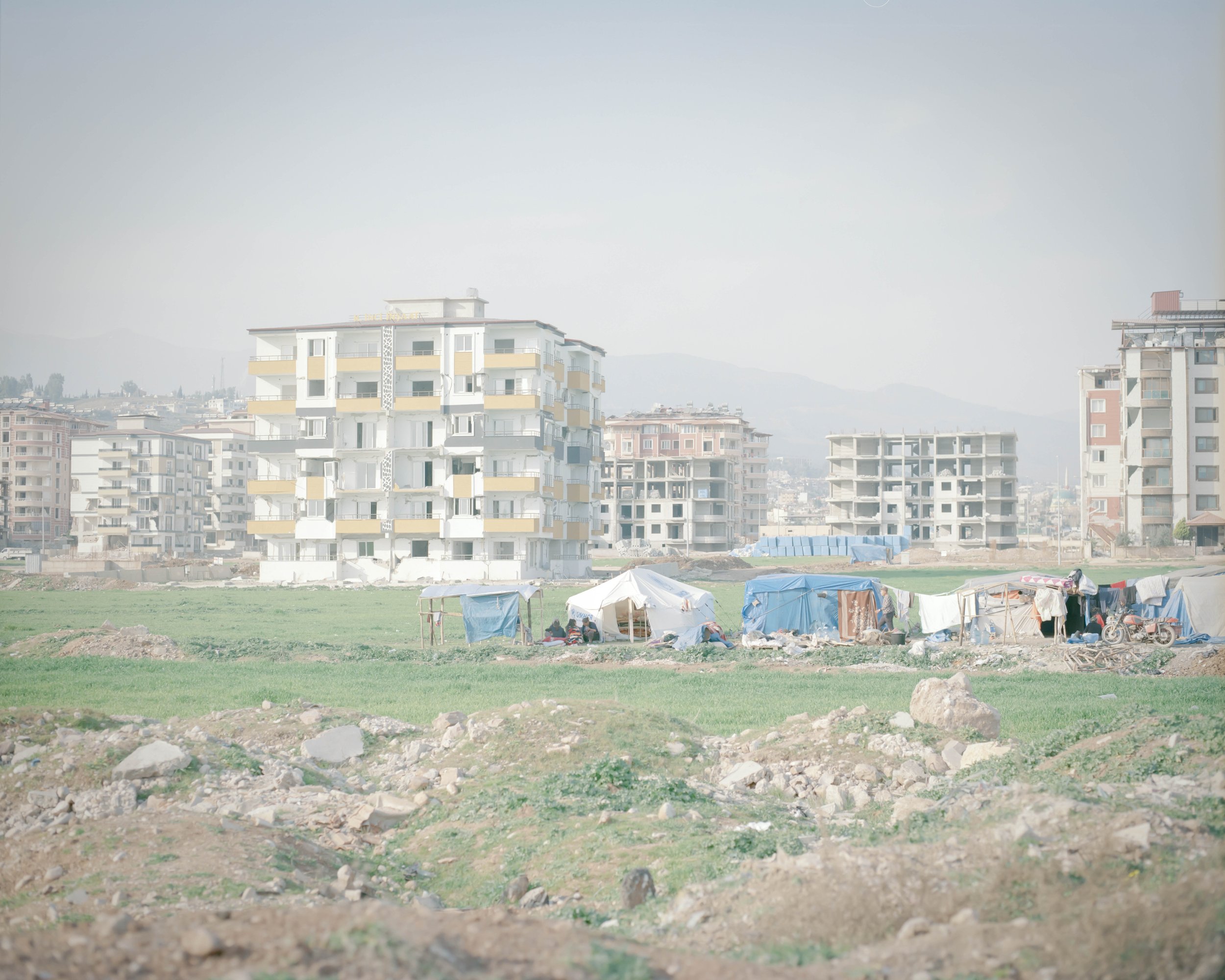 The displacement tents near the buildings have been left behind due to the risk of collapse.