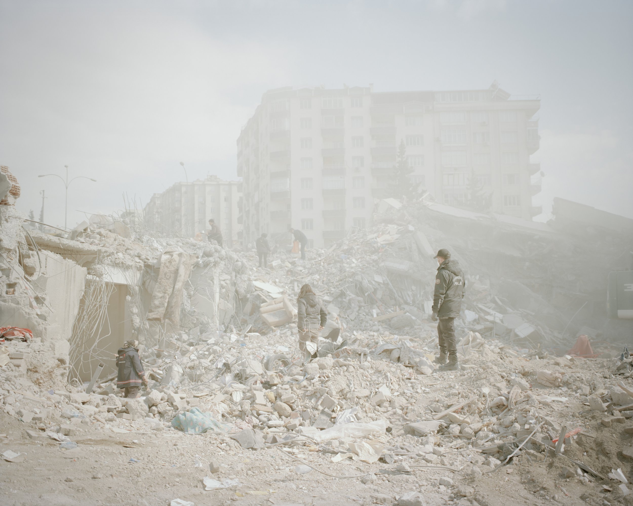 The residents and rescue are searching for something to use in the rubble.