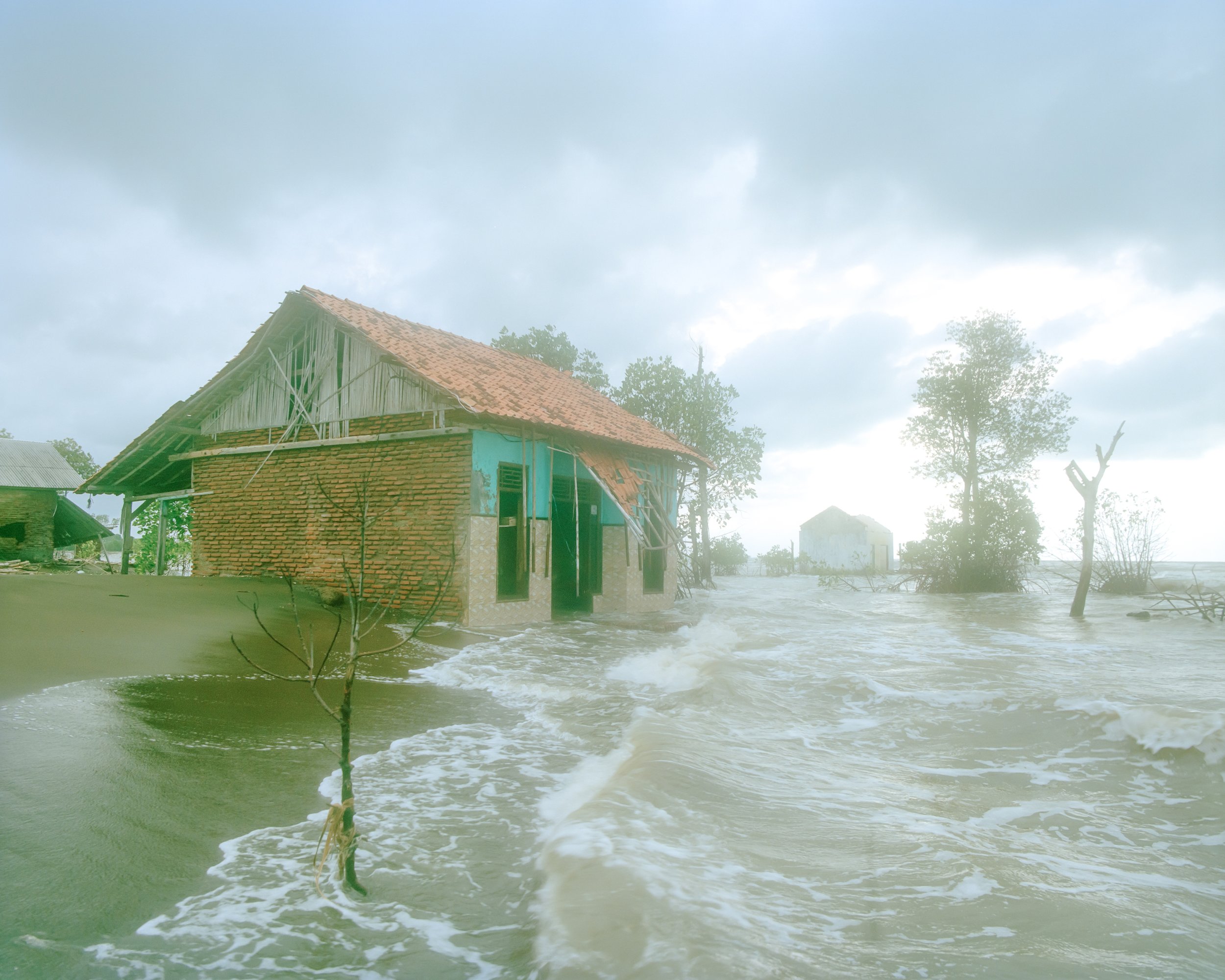 Waves crash on the abandoned houses. All the villagers have already left this village because
it has been gradually sinking into the sea due to the severe impacts of rising sea levels. (Indonesia, Central Java, Pekalongan, 2025)