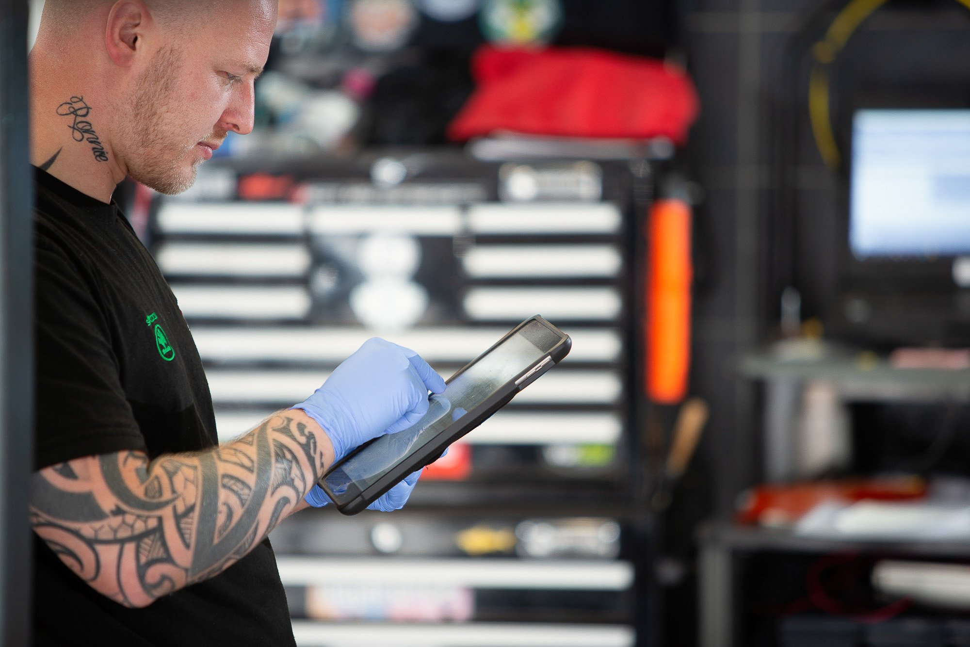 Car mechanic checking data with a tablet.jpg