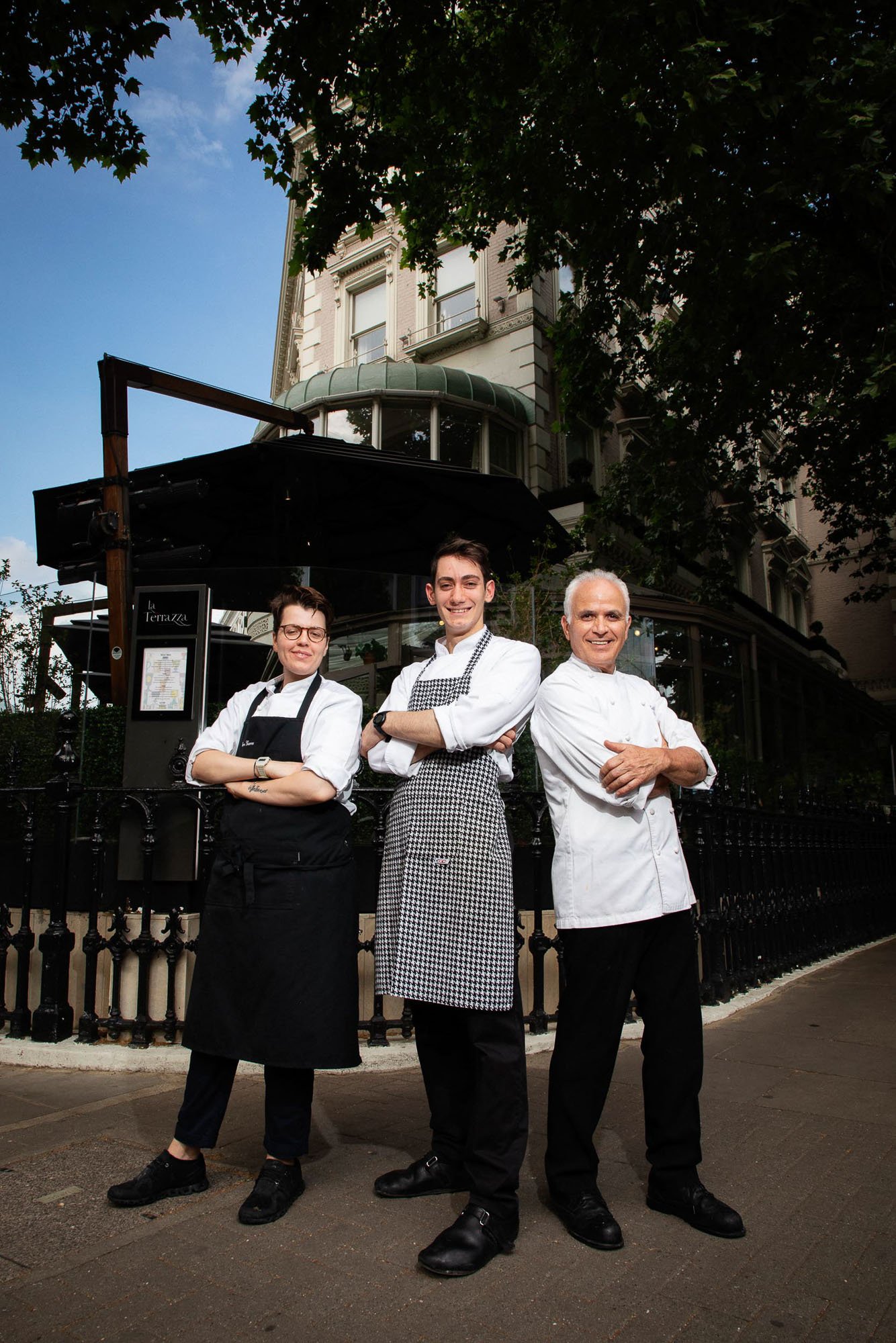 Group of Italian chefs standing outside their restaurant smiling at the camera.jpg