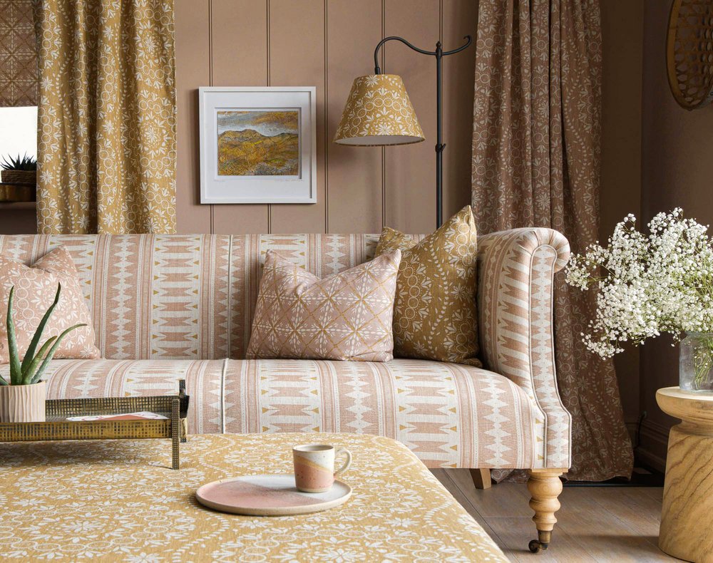 Room set showcasing cushions and a settee upholstered with fabric from the Aventuras Collection by designer Zoe Glencross.jpg