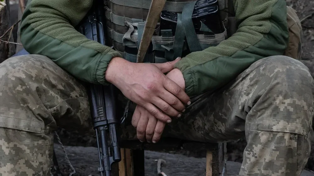 Armed soldier seated