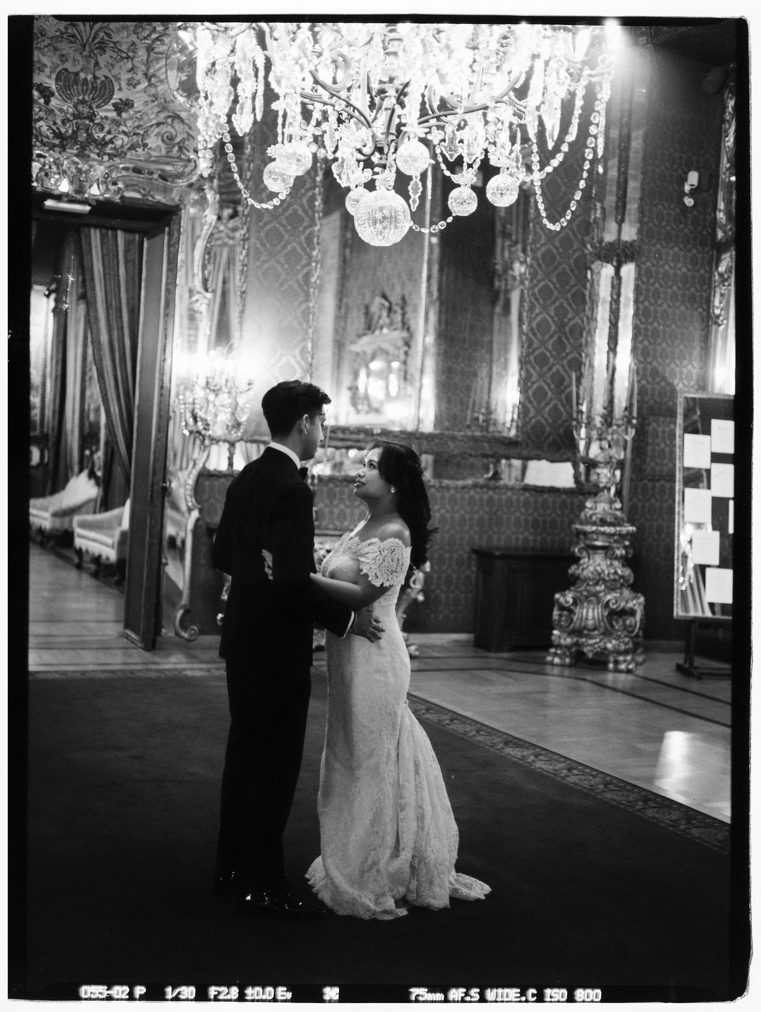 Couple dancing in Italian villa during European destination wedding captured by film photographer with documentary style.