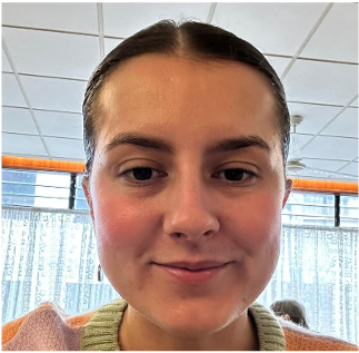 Head-and-shoulders photo of a Health Liaison Team member photographed indoors with ceiling lights visible in the background.
