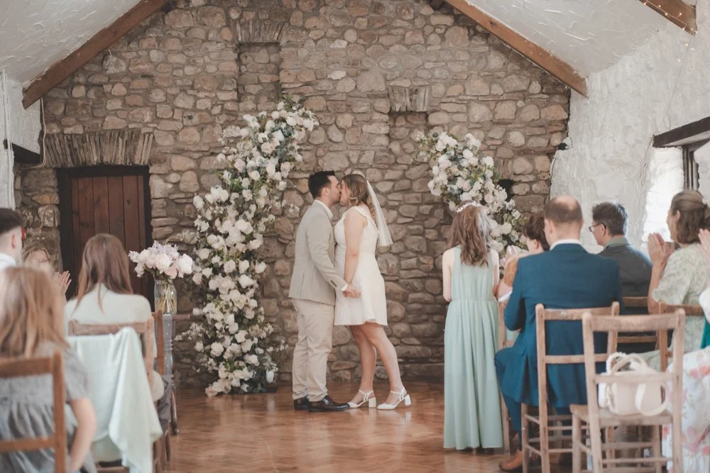 Couple's first kiss as bride and groom at Clyne Farm Centre