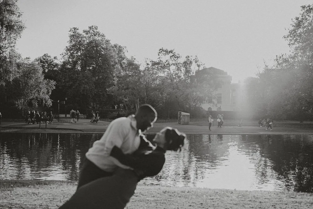 Black and white photo of a couple doing a dip in Regent's Park, London, at a pre-wedding photo session