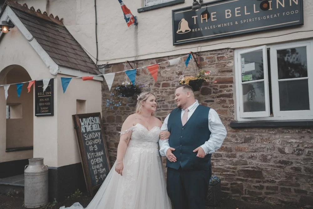 Bride and groom in front of a pub, in Wales, Uk