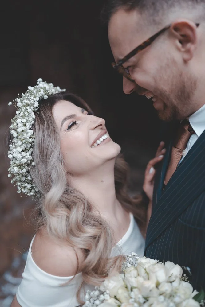 Close-up portrait of Bride and groom holding each other and laughing at a wedding in Coventry
