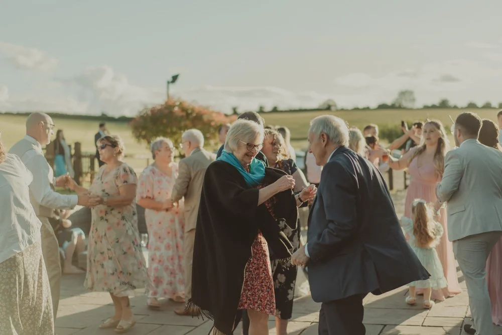 Guests at Wellington Barn, Wiltshire, dancing on the outside dancefloor 