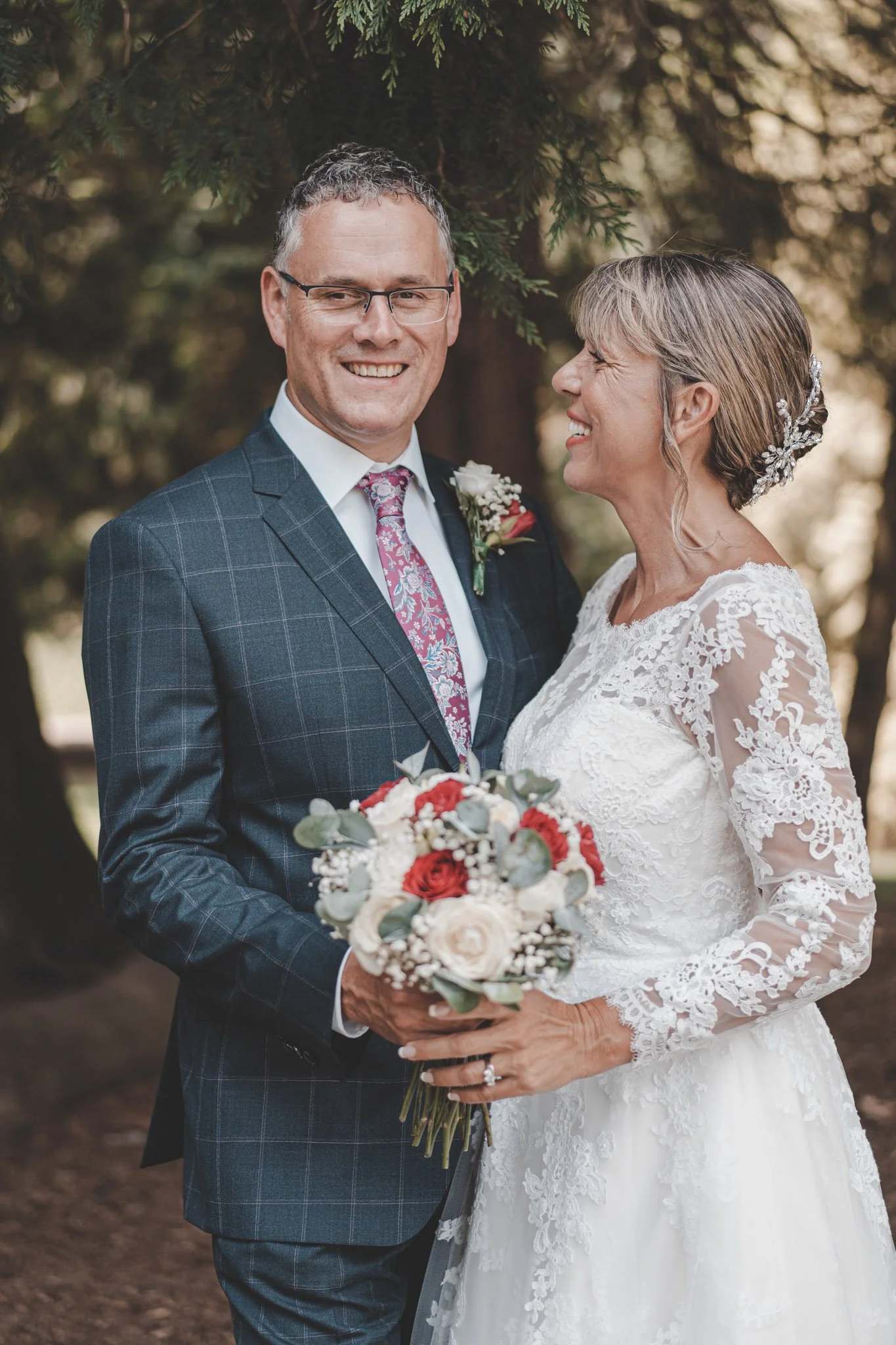 bride and groom having a good time during their wedding day photoshoot in Coombe Abbey park, Coventry