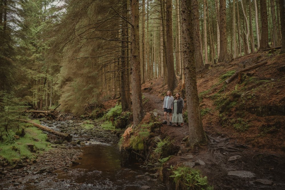 Queer couple and their dog photographed in Snake Woodland, UK