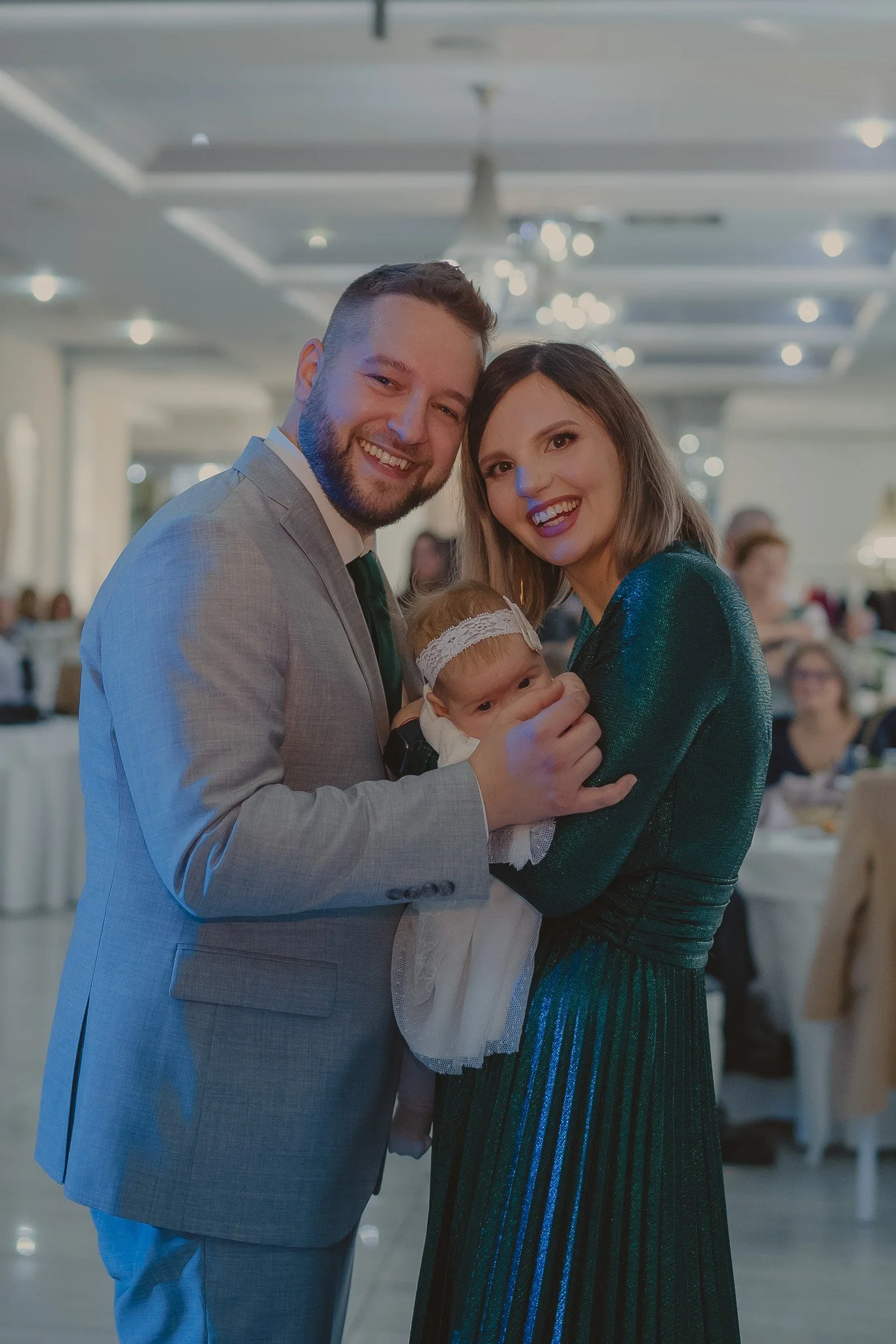 Portrait of parents holding their little daughter at Hotel Royal Classic, Cluj-Napoca, Romania