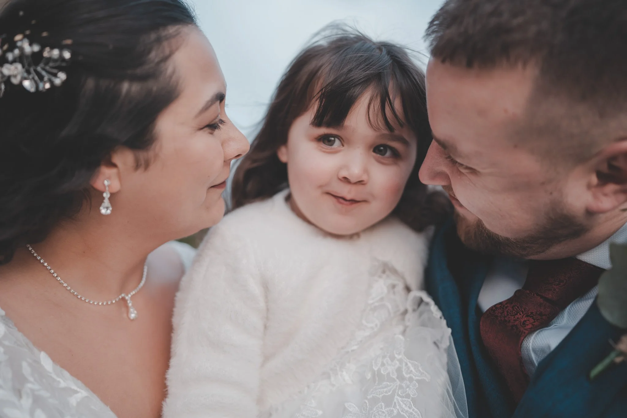 Portrait of a bride and groom with their daughter during their wedding day at Cockliffe Country House, Nottingham