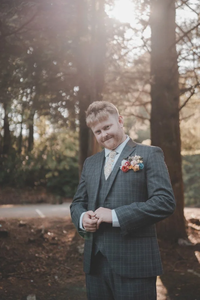 Portrait of groom with sun in the back, on the grounds on Whitehall Hotel Darwen, UK