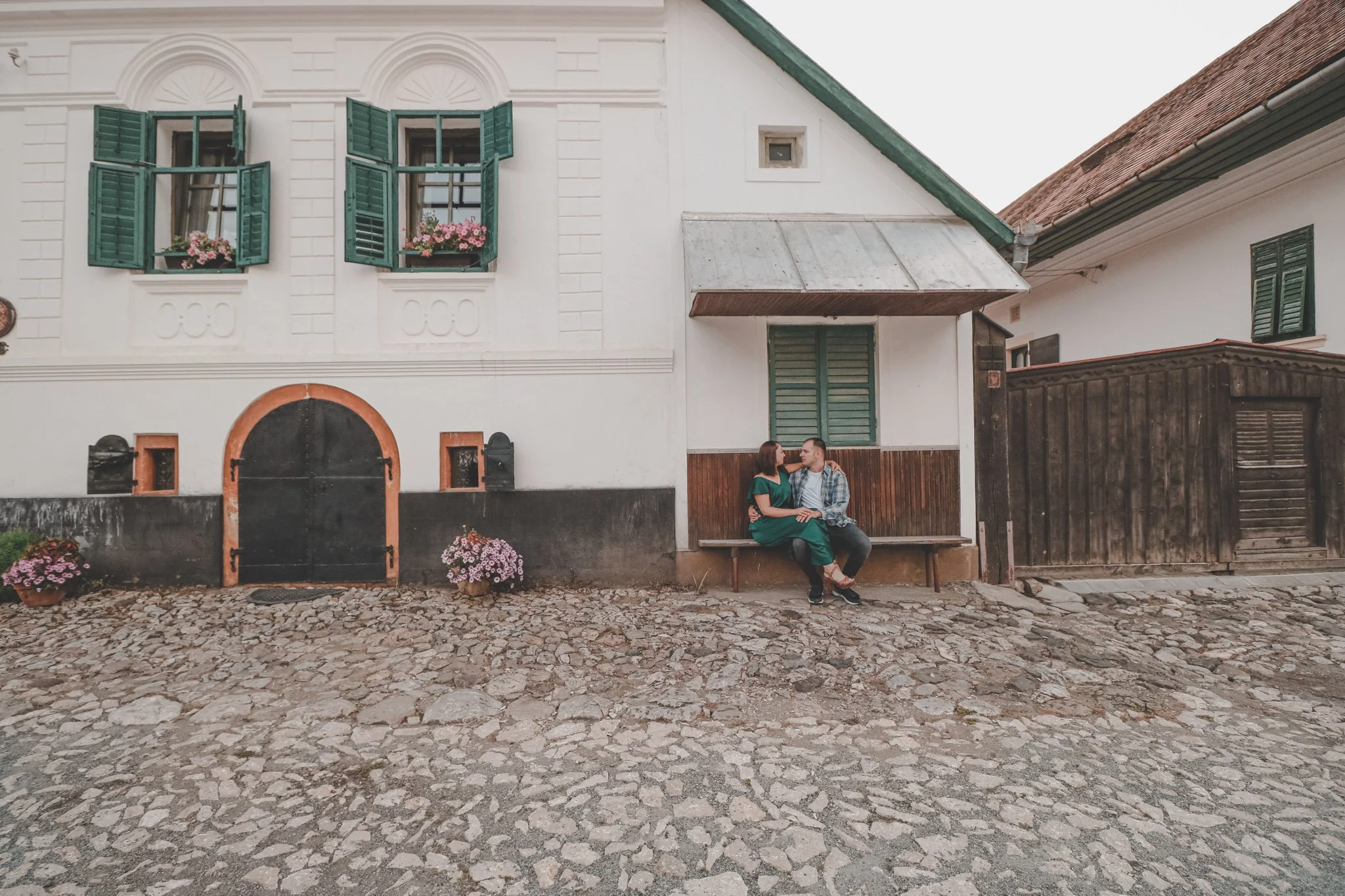 Couple posing on a bench in a picturesque village in Rimetea, Alba, Romania