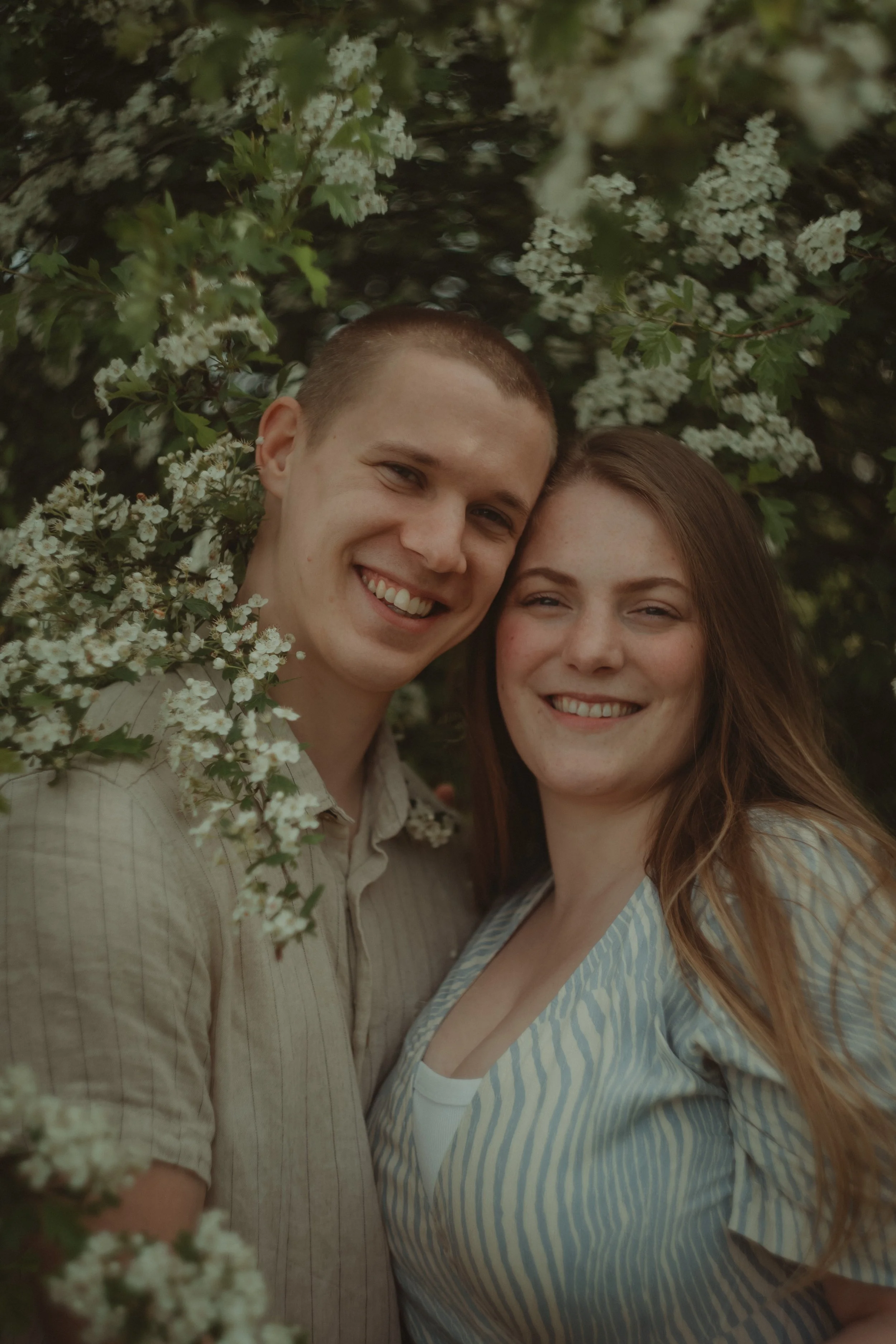 Close-up portrait of a couple smiling at the camera
