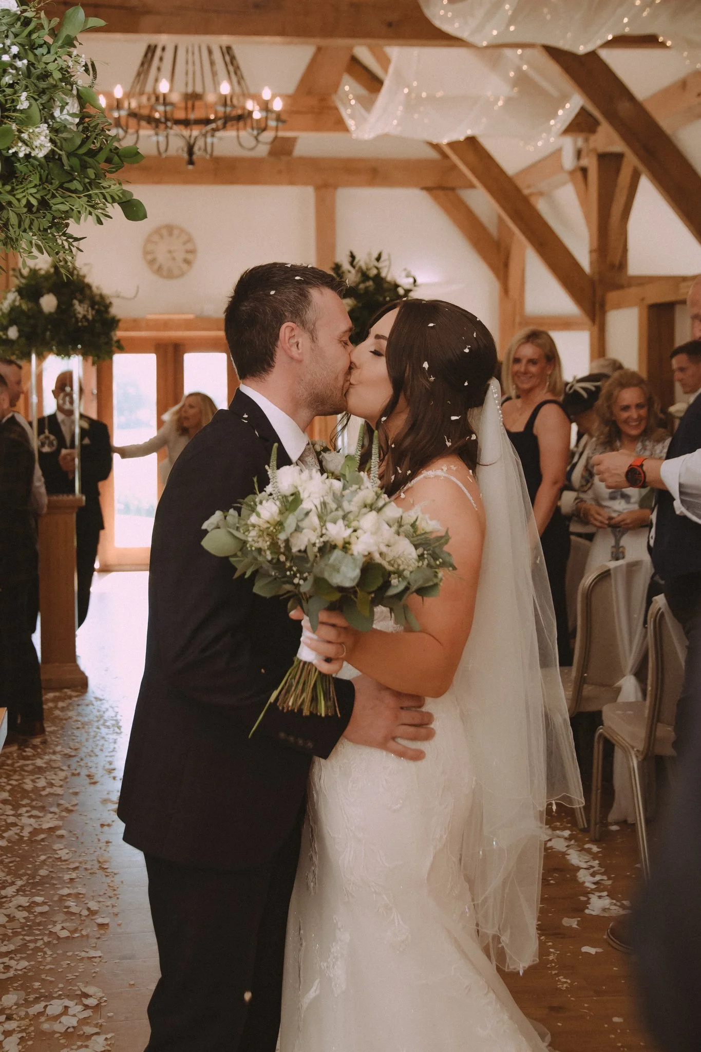 Bride and groom kiss after their wedding ceremony at Sandhole Oak Barn Wedding Venue