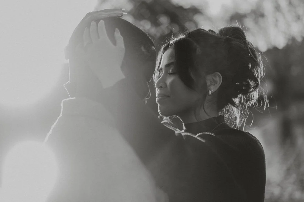 Black and white close-up portrait of engaged couple, in the sun, in Regent's Park, London