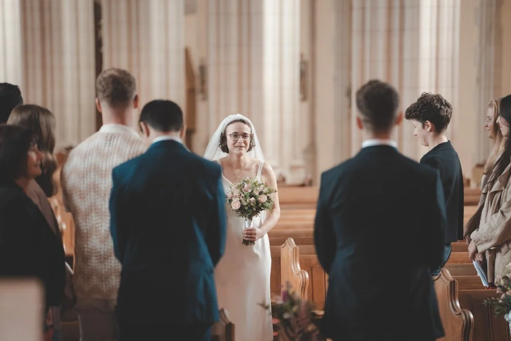 Bride walking down the aisle at St Benedict's Ealing Abbey, London